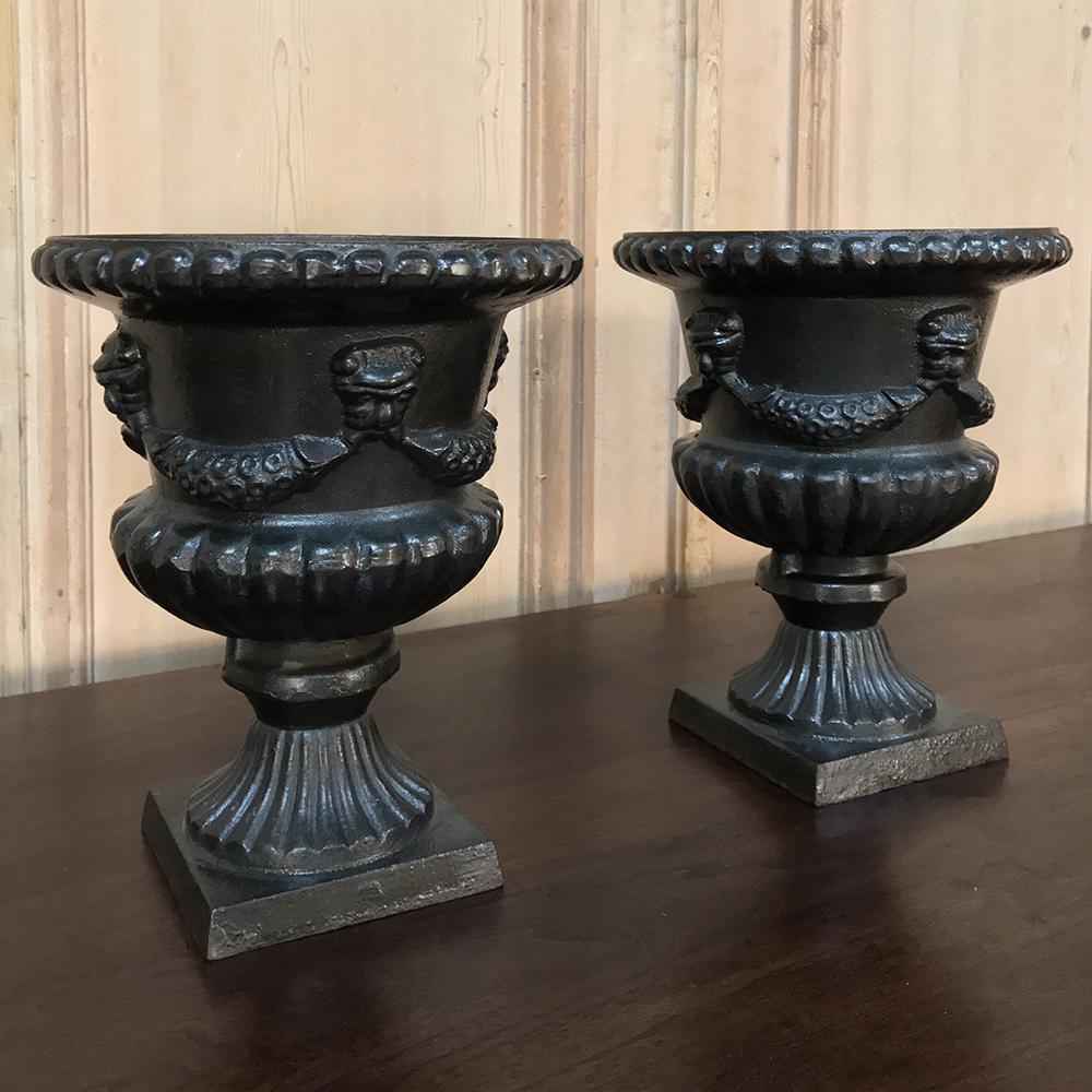 Pair 19th Century Neoclassical Cast Iron Garden Urns are ideal for exterior or interior use.  Each is a heavy casting that features a splendid neoclassical design inspired by ancient Greek and Roman architecture, with a wide opening at the top.  The