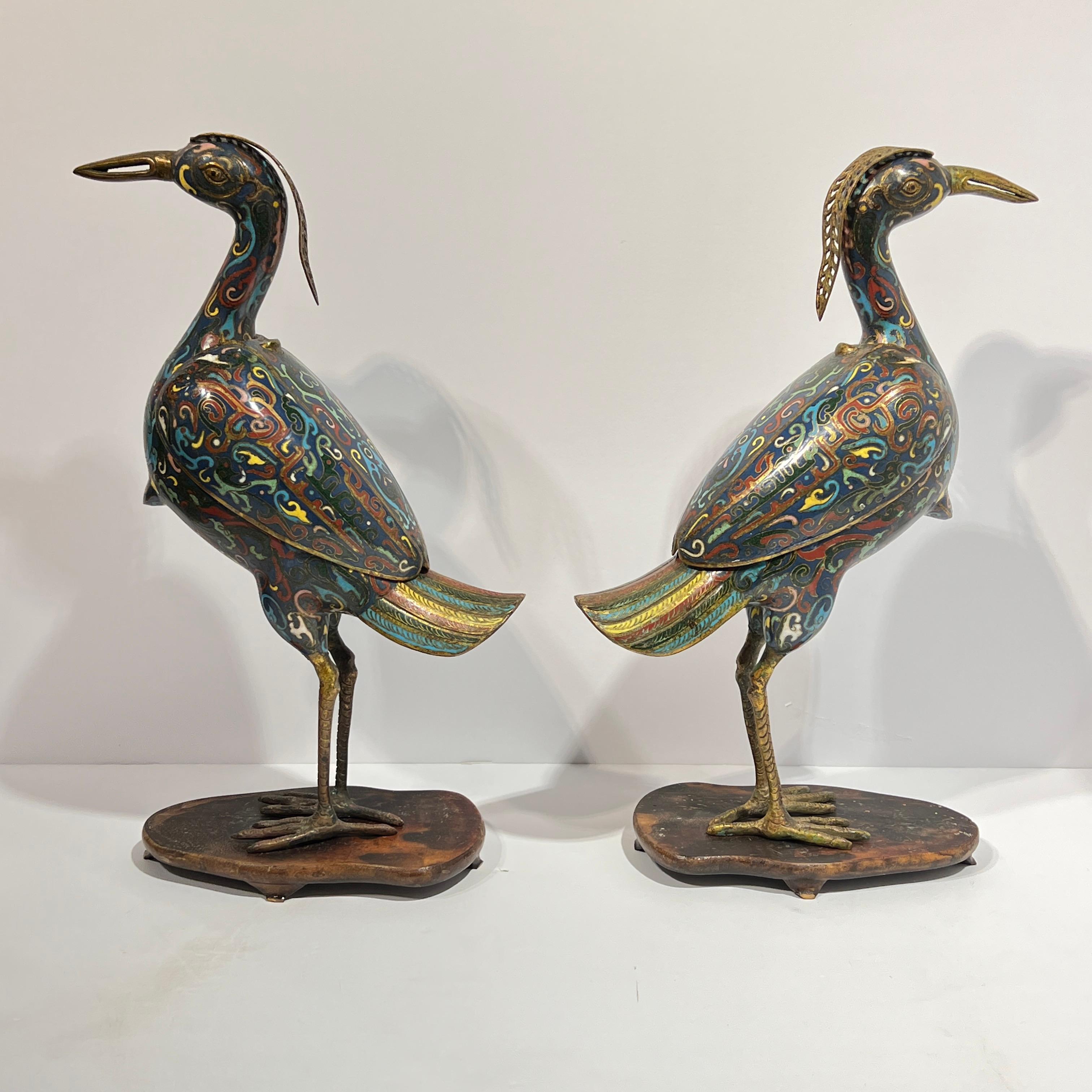 Pair of antique Qing period Chinese cloisonne enameled censers in the form of quail birds.  With later ebonized wooden stands.  Total measures 14 1/2 by 9 by 4 inches.