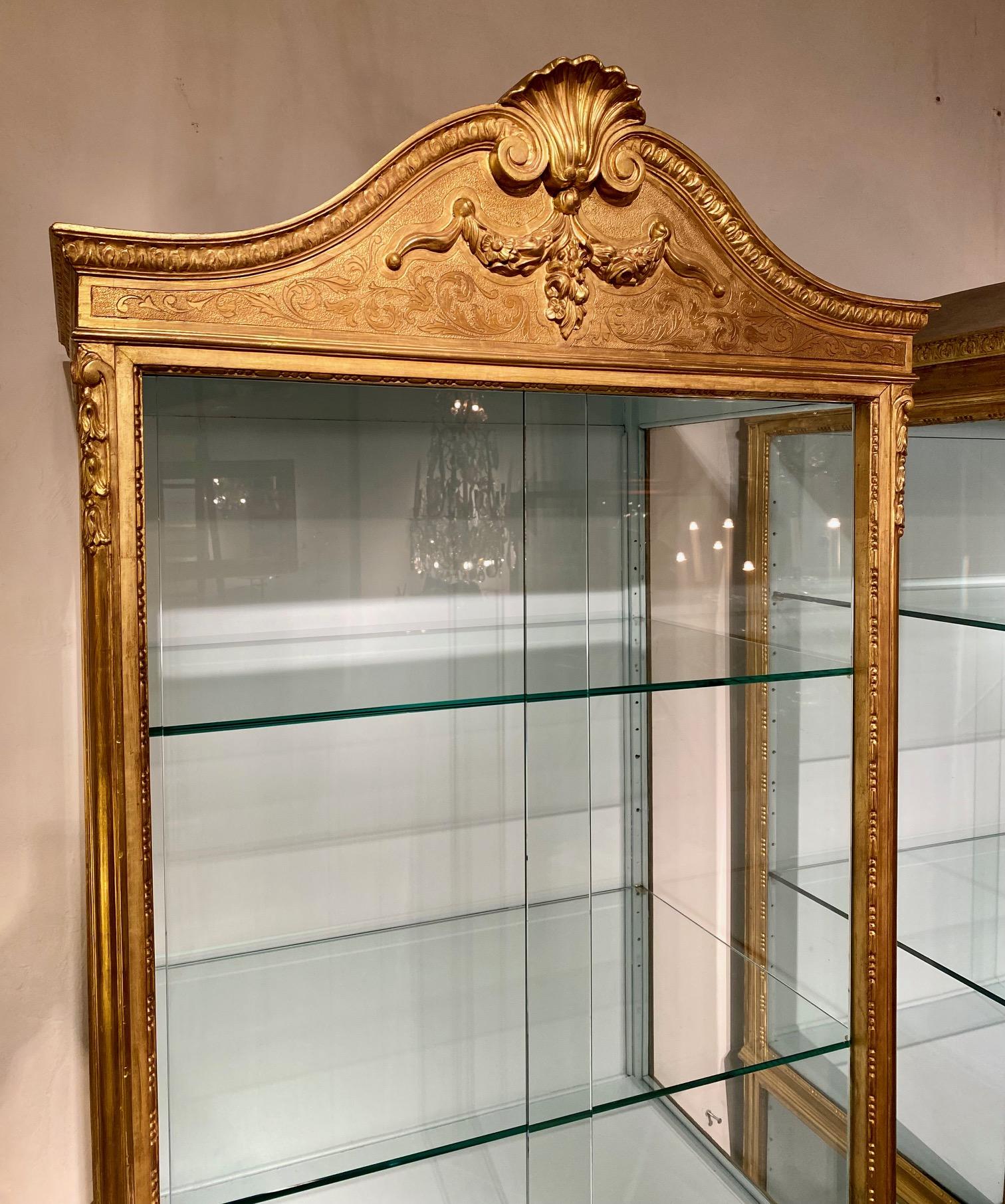 Francese Pair 19th century  Regence style vitrines in gilded wood. in vendita