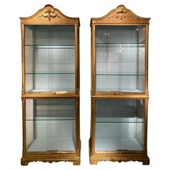 Pair 19th century  Regence style vitrines in gilded wood.