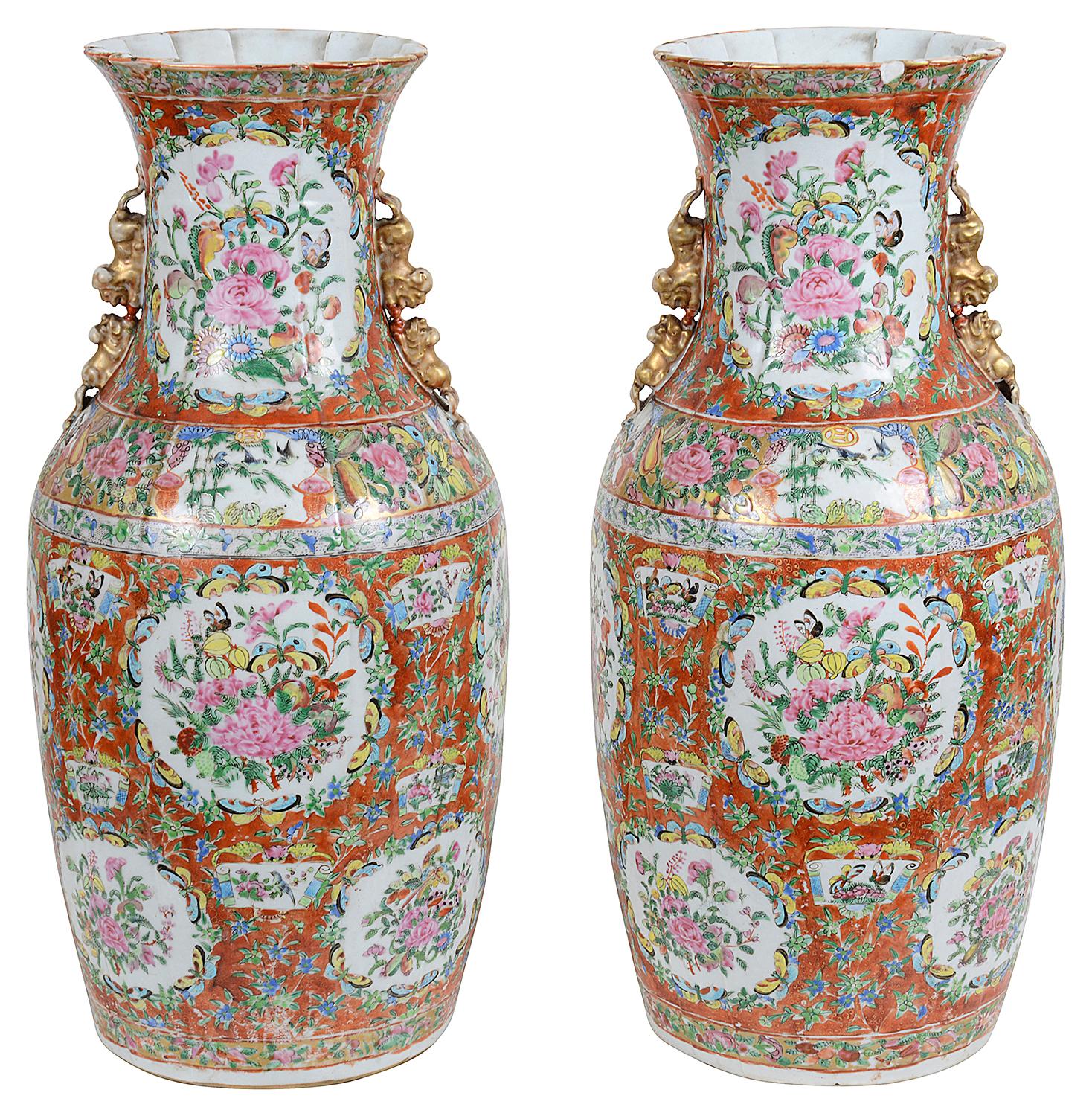 A very good quality pair of 19th century Chinese Cantonese, Rose medallion vases, each with unusual orange ground, inset painted panels of exotic flowers, foliage and butterflies, a pleated neck and mythical dog of foo handles.
 