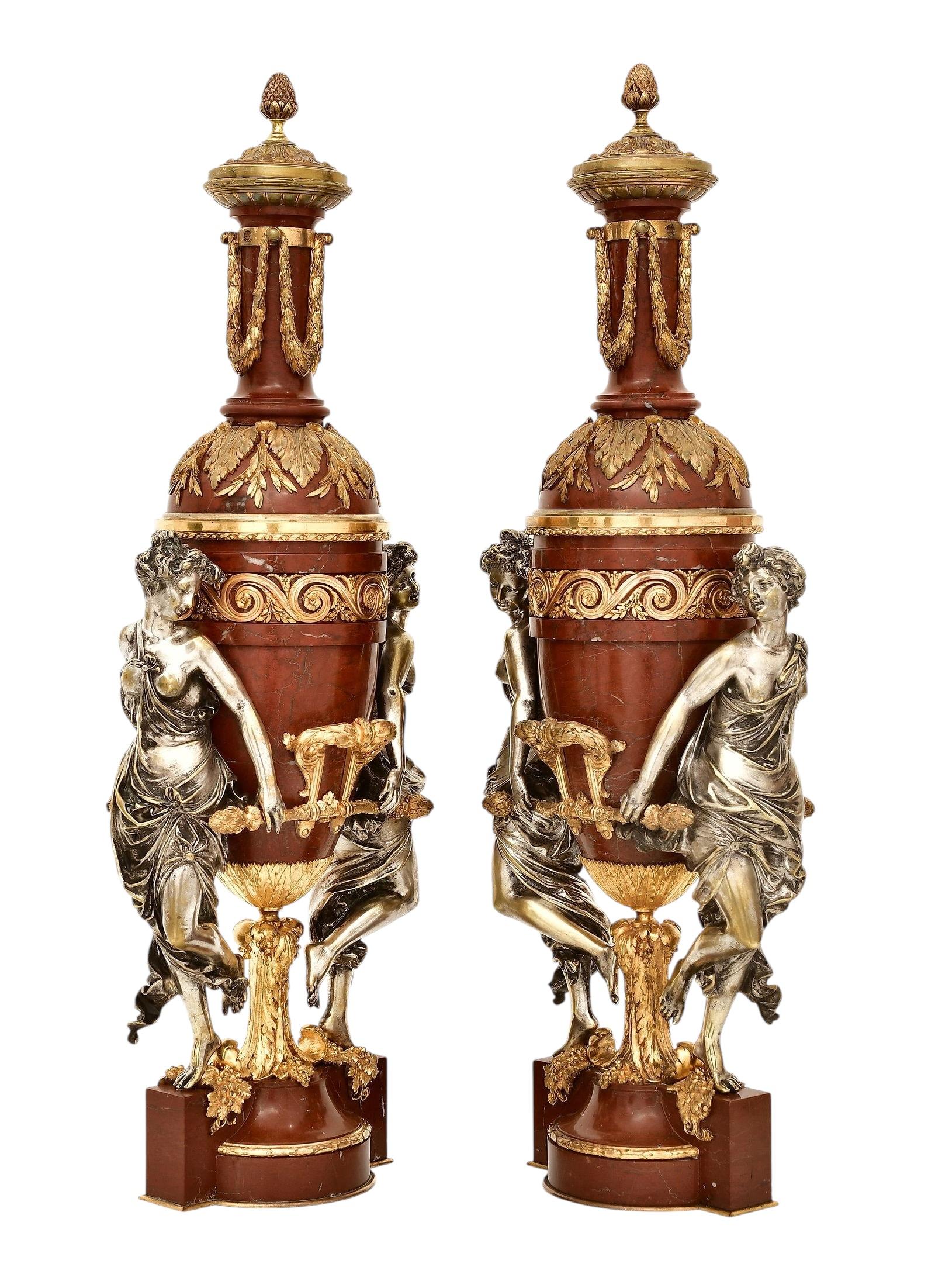 Pair of large antique (19th century) French oil lamps crafted from rouge marble with gilt and silvered mounts including the prominent figures of neoclassical maidens.  By Maison Gagneau, late 19th century. 29 by 10 1/2 by 6 1/2 inches.  Hardware