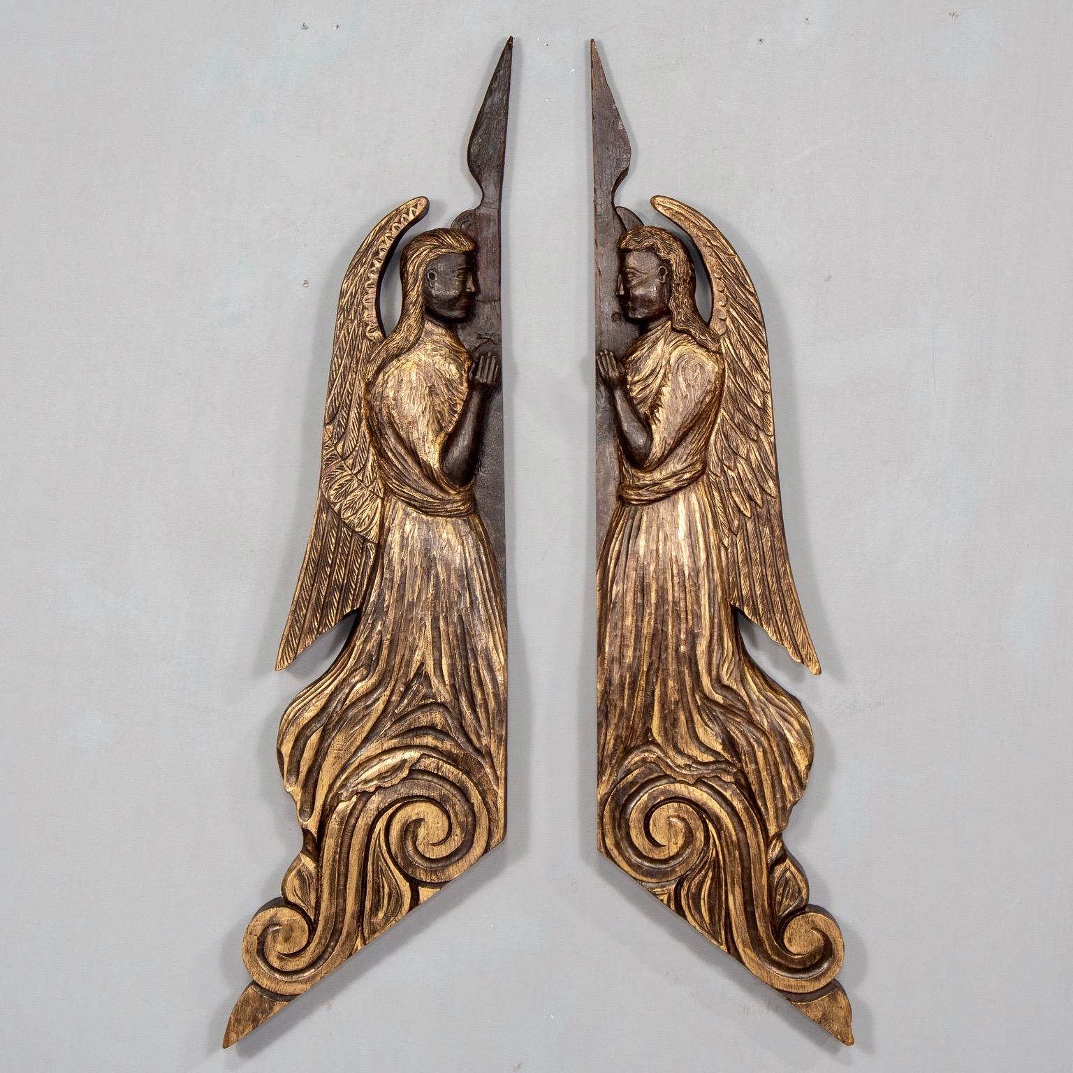 Pair of Scottish chip carved angels was originally created to hang on either side of a doorway, circa 1880s. Dark stained wood has been professionally finished with gilding wax to accentuate carved details. Angels are sold and priced as a pair.