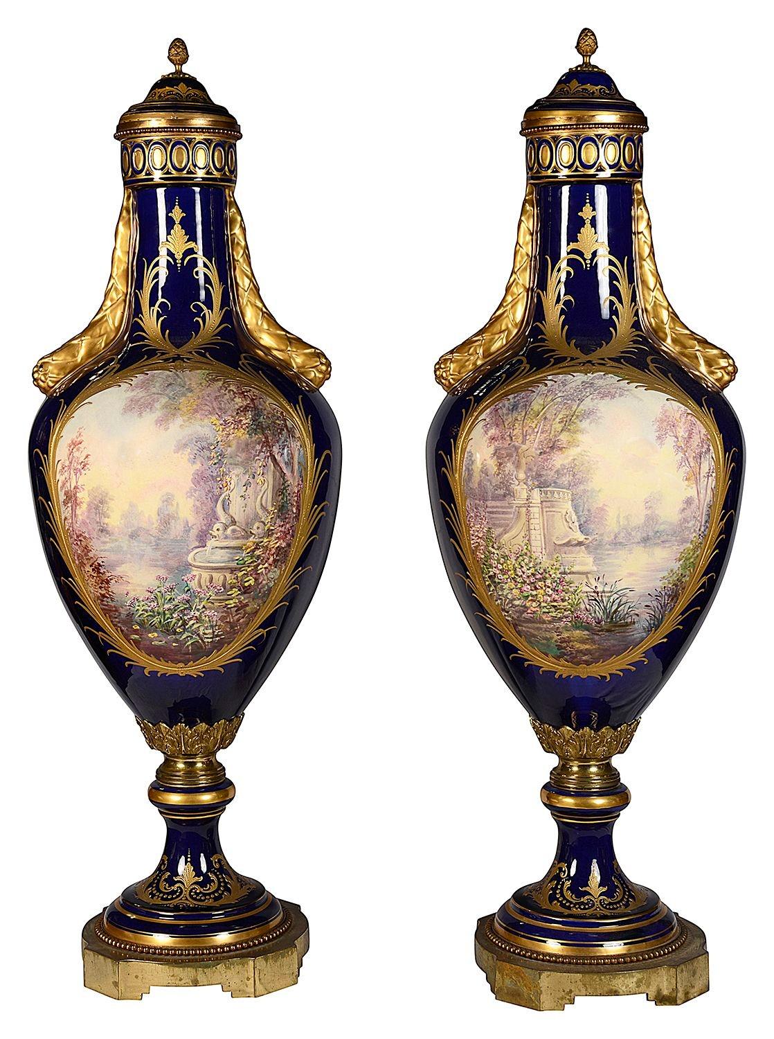 A fine quality pair of French Serves style porcelain lidded vases, each with a cobalt blue ground, wonderful gilded classical highlighted decoration, with inset hand painted romantic scenes of lovers courting, signed 'J.Pascot'
 
 
 
Batch 73 61860