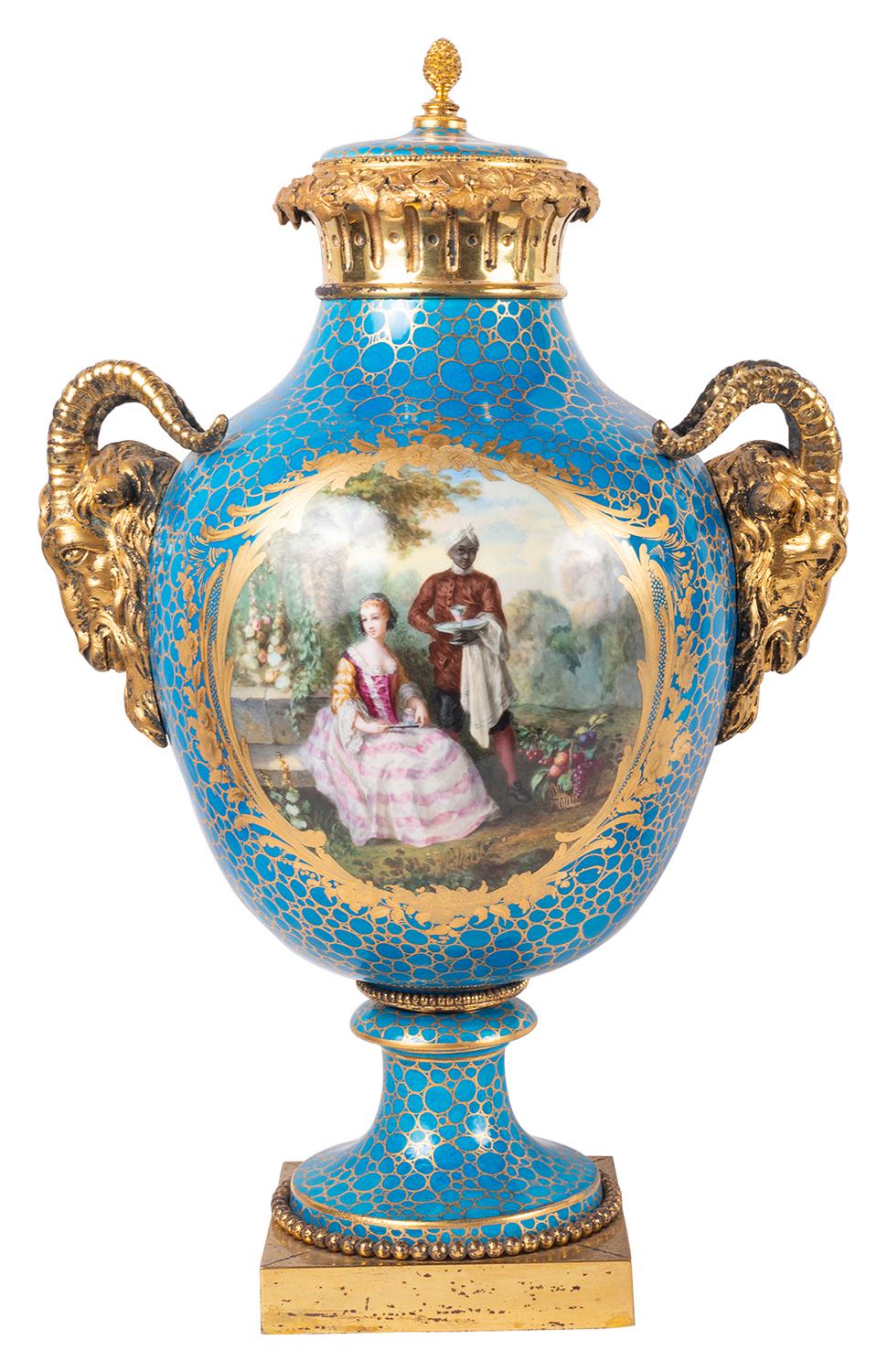 A very good quality pair of French classical late 19th Century Sevres style porcelain, ormolu mounted vases. Each with turquoise ground, inset hand painted panels depicting romantic scenes and floral scenes to the reverse. 
Gilded ormolu Rams head