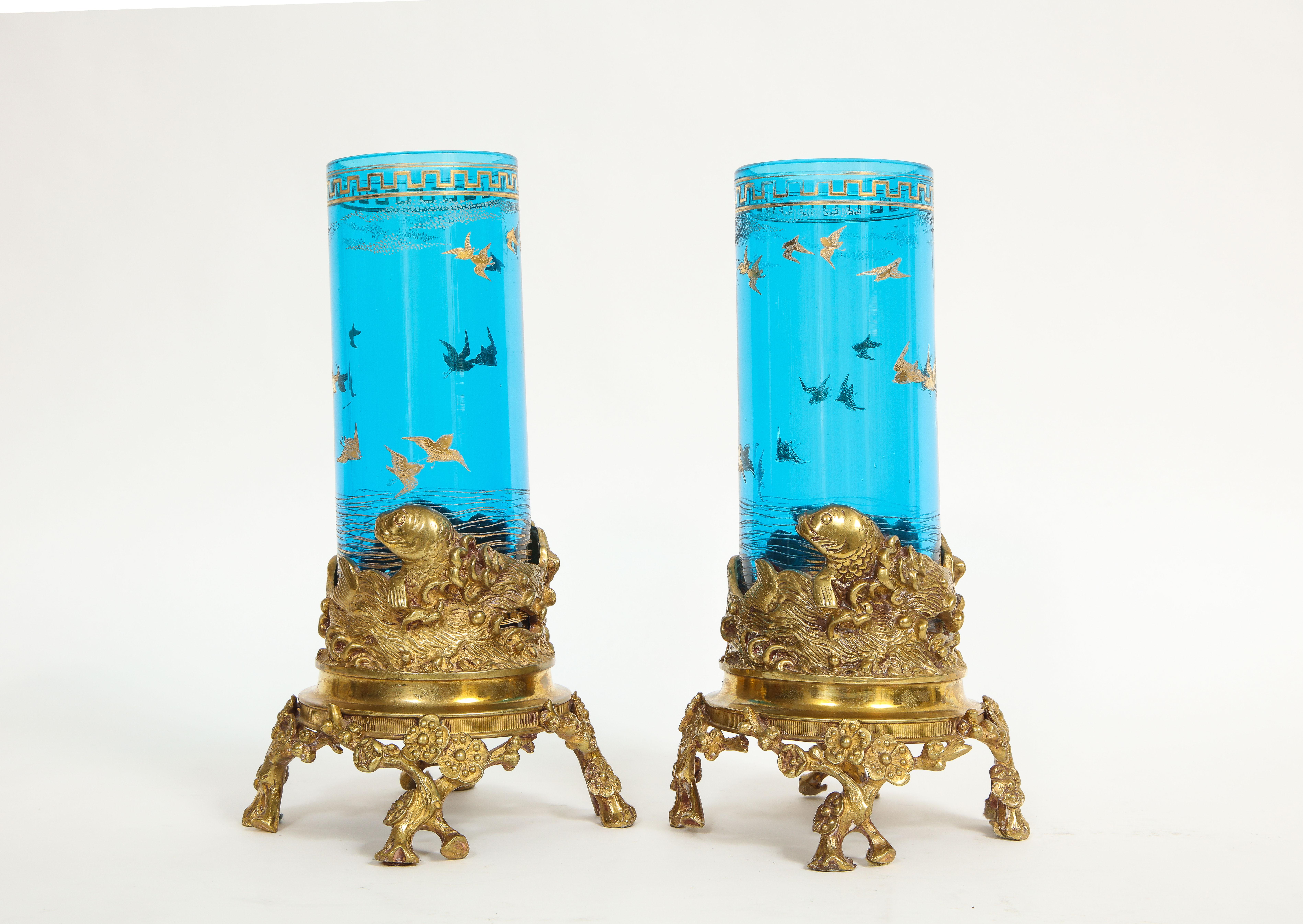 A pair of 19th century French signed Baccarat dore bronze mounted blue etched and gold filled crystal nautical form vases. Each vase has two components, gorgeous bronze mounts and blue crystal vases. The blue crystal vases are of the finest quality