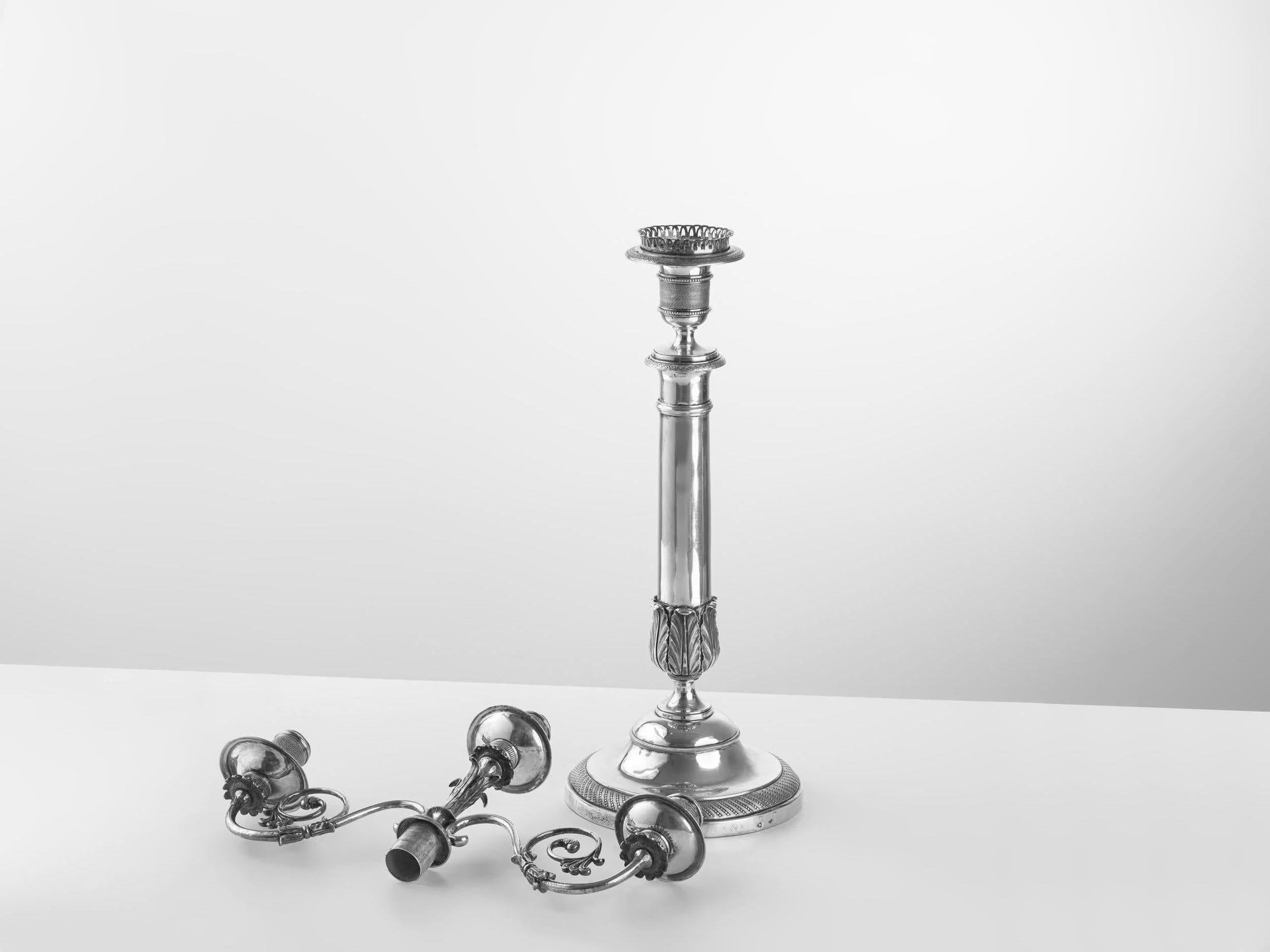 Pair of 19th century silver candelabra with a round base and with removable branches. High 45cm,
marks Rome Stato Pontificio, with the possibility of disassembling the upper part and using them individually as candlesticks.