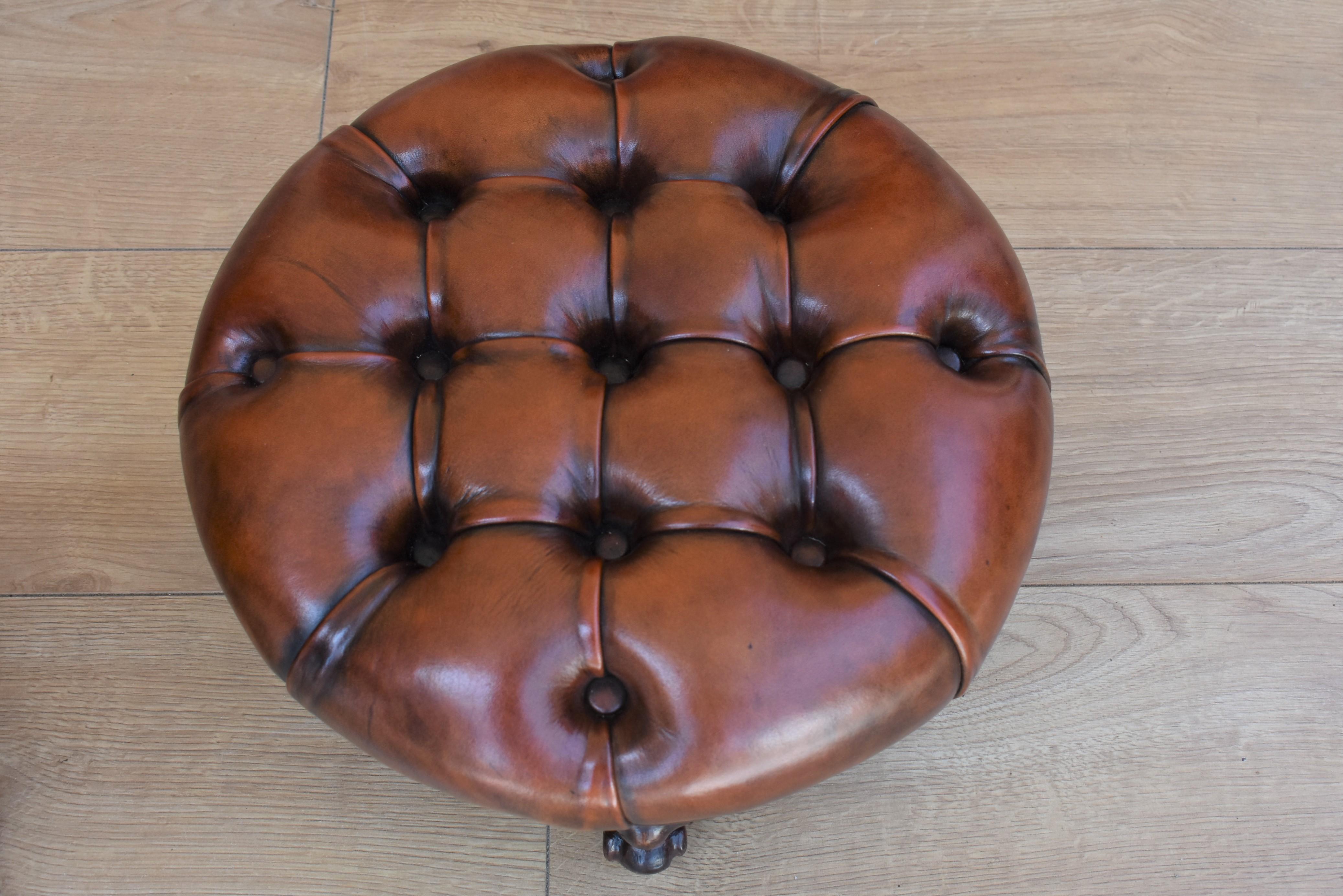 Pair of Victorian footstools that have been upholstered in antique brown leather, deep buttoned and hand dyed with close studding to the edge, standing on walnut cabriole legs.
