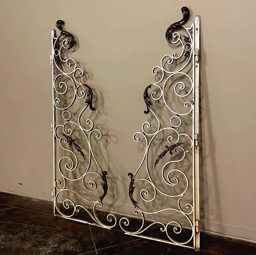 Pair 19th century wrought iron gates will make a charming entry way into your garden, courtyard, or even upside down to create an arched framework through a cased opening indoors or out! Beautiful French scrollwork abounds in a complex yet tailored