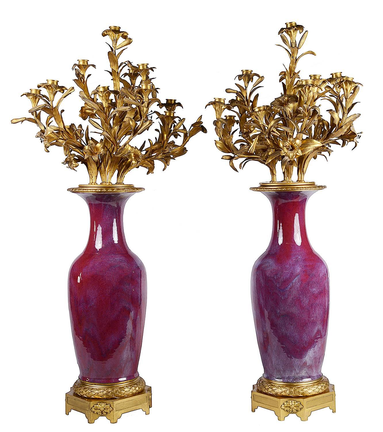 A very impressive and imposing pair of 19th century Chinese Sang De Boeuf vases with wonderful French gilded ormolu 14 branch floral and leaf candelabra, mounted on leaf and floral mounted plinth bases.