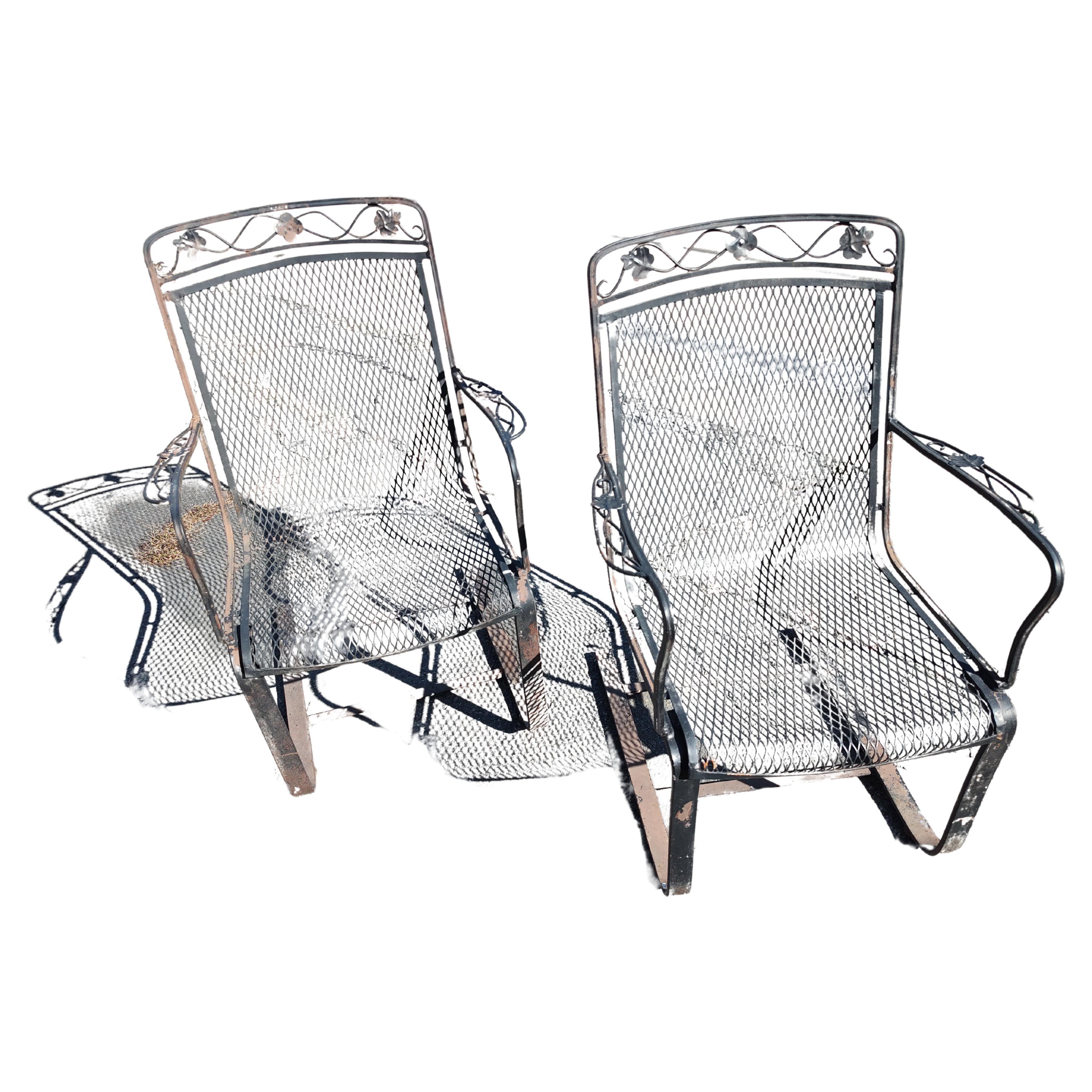 Fantastic pair of Mid Century Modern Sculptural Iron cantilevered lounge chairs in old black paint c1960. Very comfy as they have a spring like mobility since they are cantilevered the chairs will lean back accordingly. What appears to be the