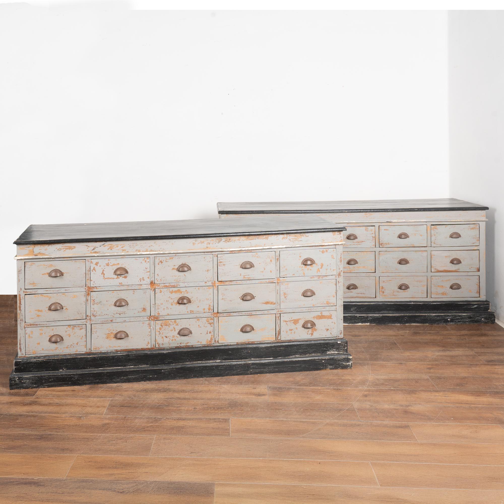 Two pine apothecary counters with 15 drawers each; both are painted gray with a contrasting black top and base.
This pair may be placed back to back, increasing the depth to 48