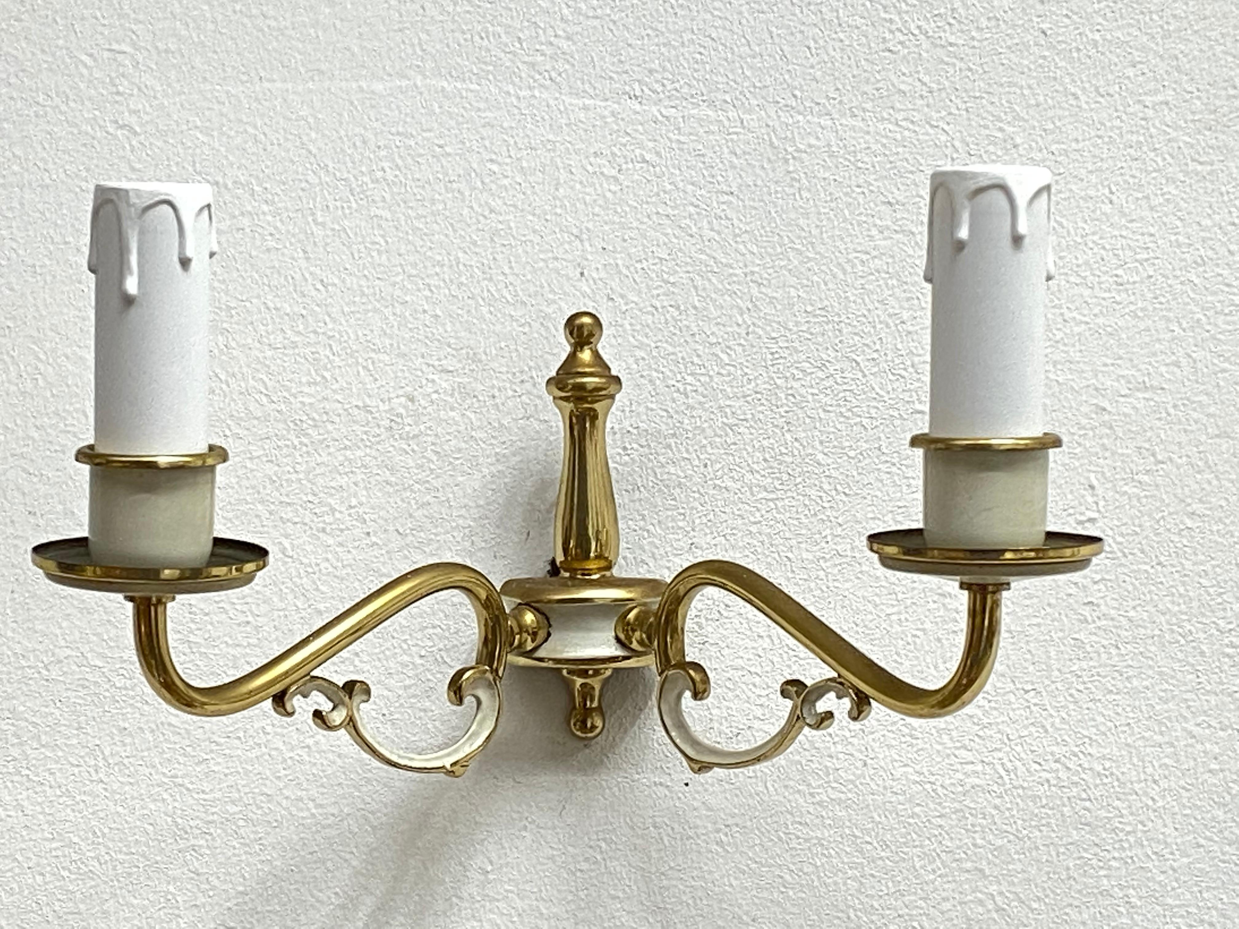 Add a touch of opulence to your home with this charming pair of sconces. Perfect gilt and lacquered metal to enhance any chic or eclectic home. We'd love to see it hanging in an entryway as a charming welcome home. Built in the 1960s, in Germany,