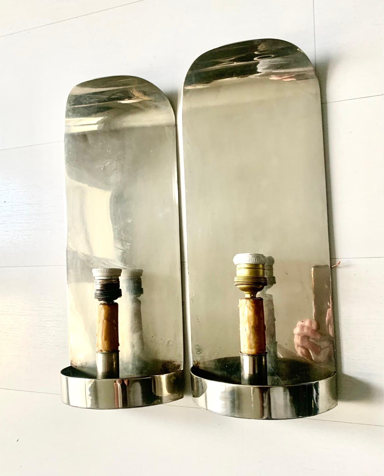 A pair of vintage sconces from the 70s, from the Valenti house, made of chromed metal with a wax bulb base imitating a candle, the lamp shades are original to the sconces.That's why they have some wear on the edges.
​