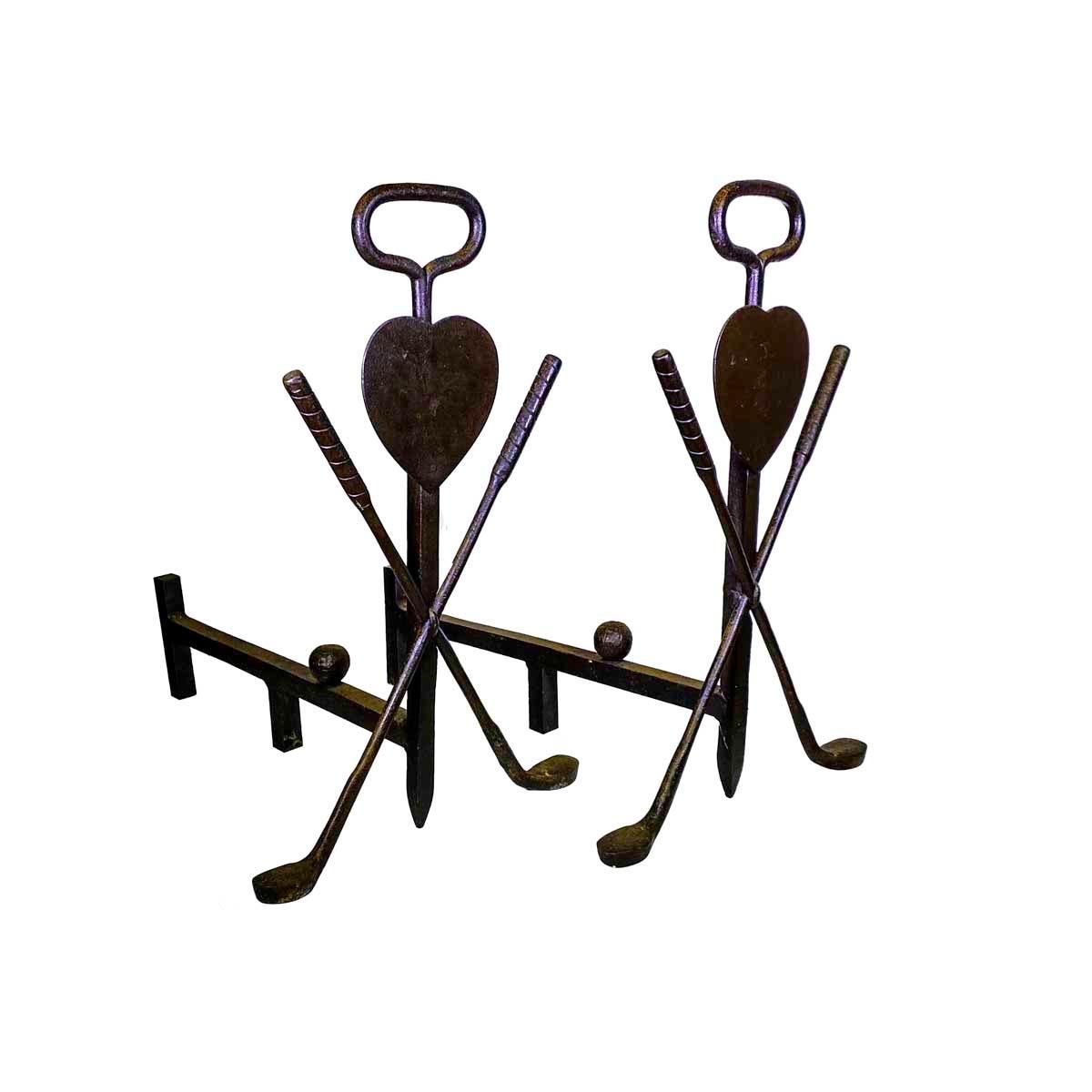 Pair of 20th century, Folk Art, golf themed andirons, having a central shaft with a loop handle and a pair of golf clubs centering a heart, the forward log stop is in the form of a golf ball. Made of wrought iron they appear to be blacksmith made.