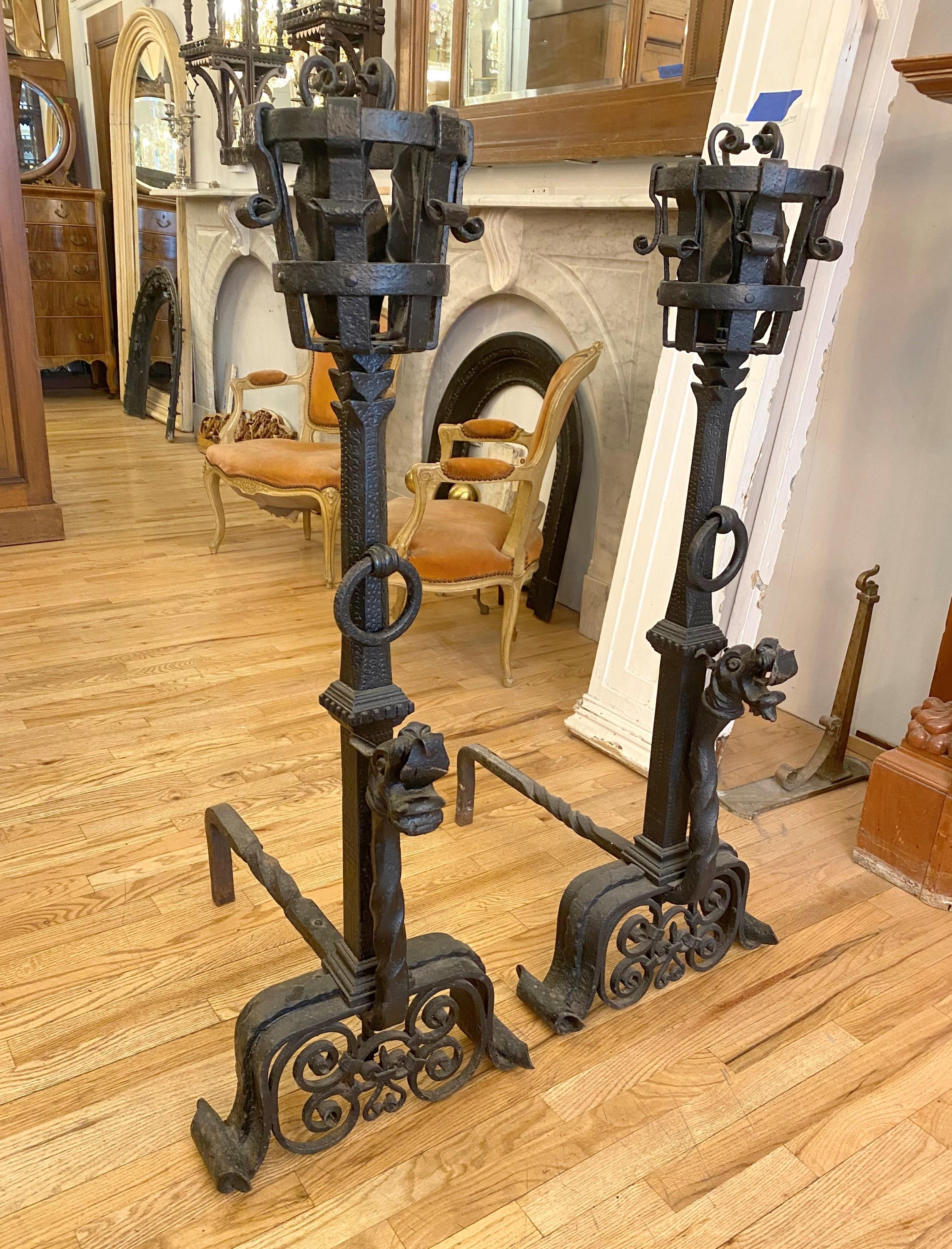 Very large ornately designed hand wrought andirons with griffin heads from the 19th century,  finished in black. They are in great condition. Priced as a pair. Please note, this item is located in one of our NYC locations.