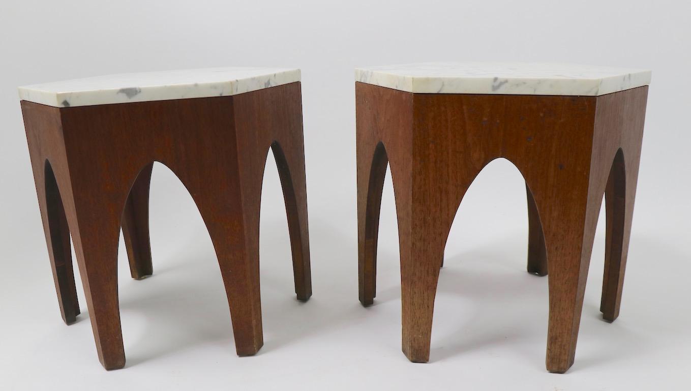 Pair of hexagonal marble top taboret tables with cathedral arch bases. These tables have period custom marble tops (1 inch thick) and walnut veneer tables. Design in the style of Harvey Probber. Priced and offered as a pair.