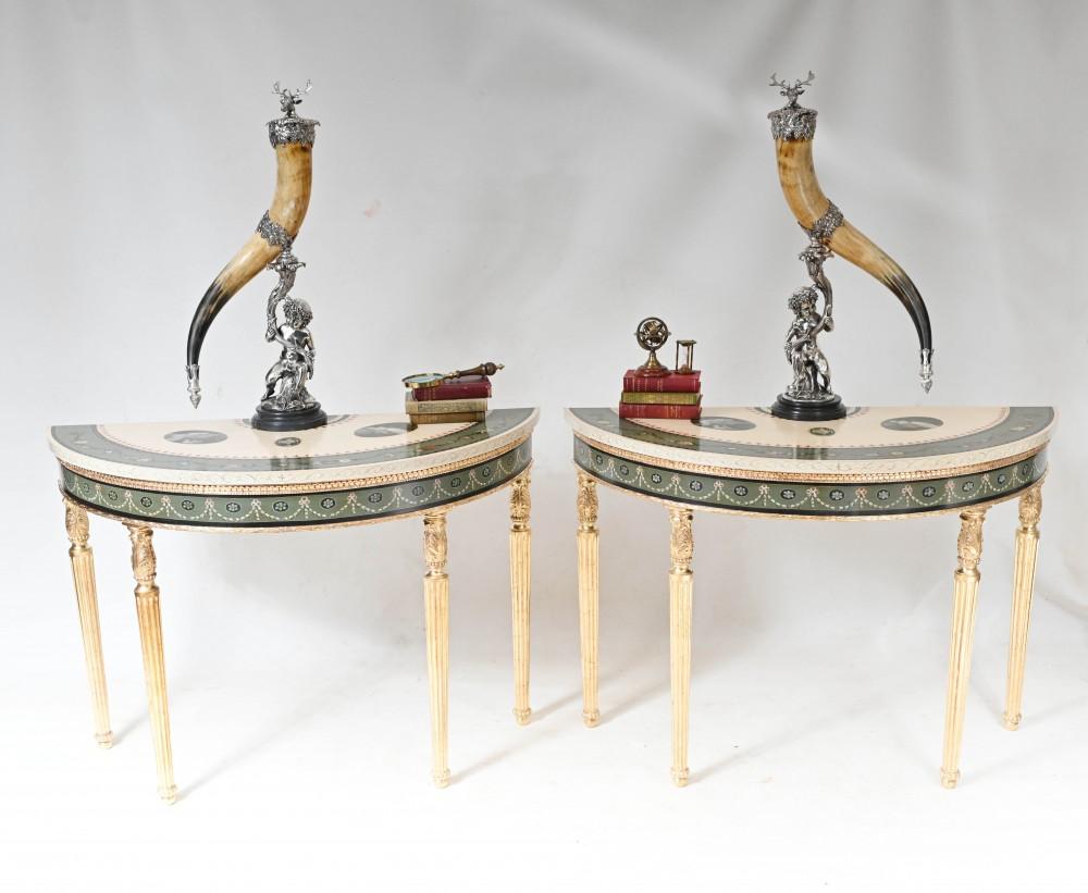Absolutely stunning pair of demi lune form console tables in the Adams manner
The height of classical refinement, this pair feature hand carved gilt bases
Classically fluted - echoing a column - legs draw the eye to the table top
Painted details