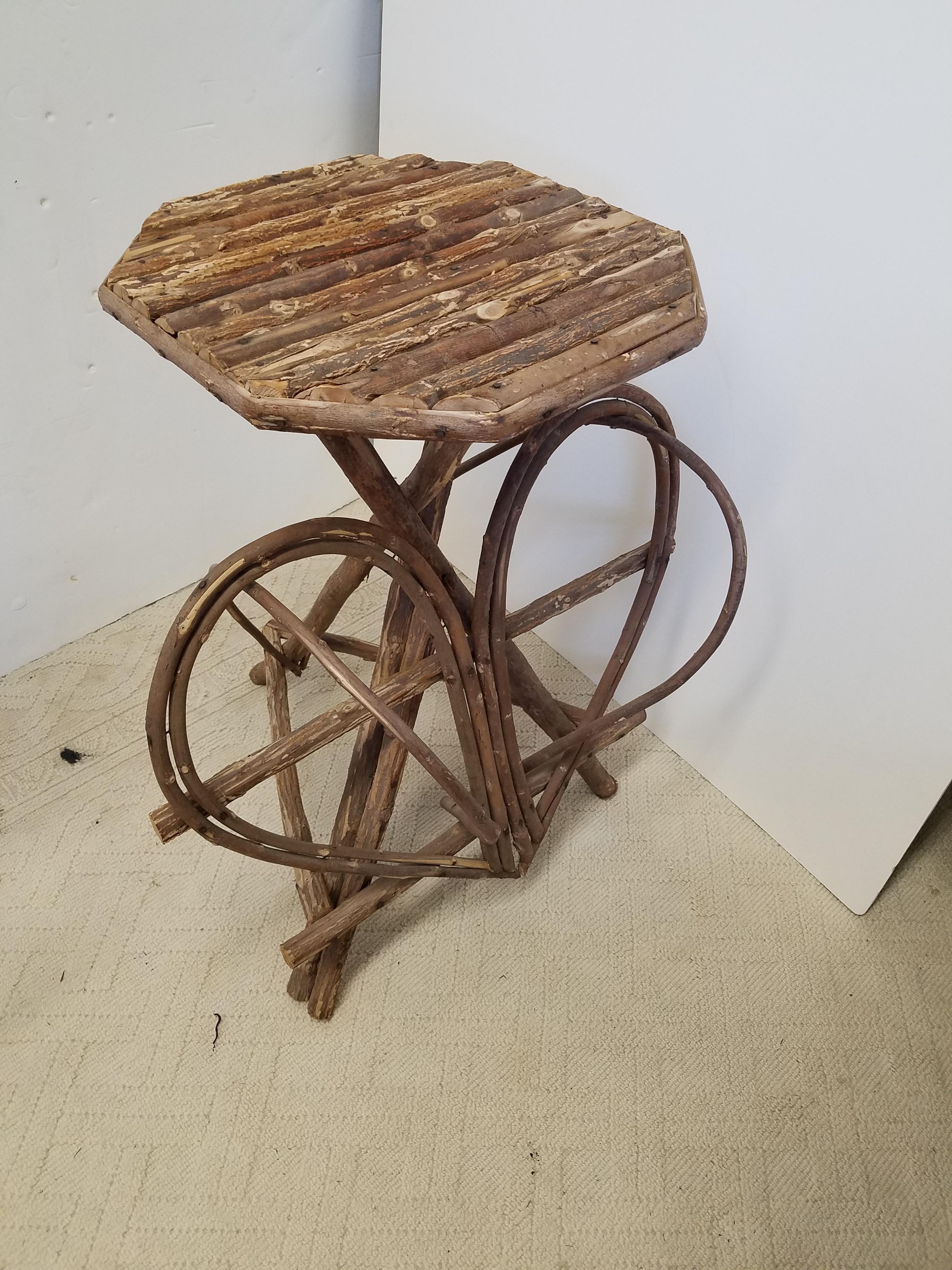 A pair of rustic twig table with octagonal tops with planked twigs with heart shaped twig bases 
1980s 28 W x 21 D x 29 H. Tops are 16.75 W.