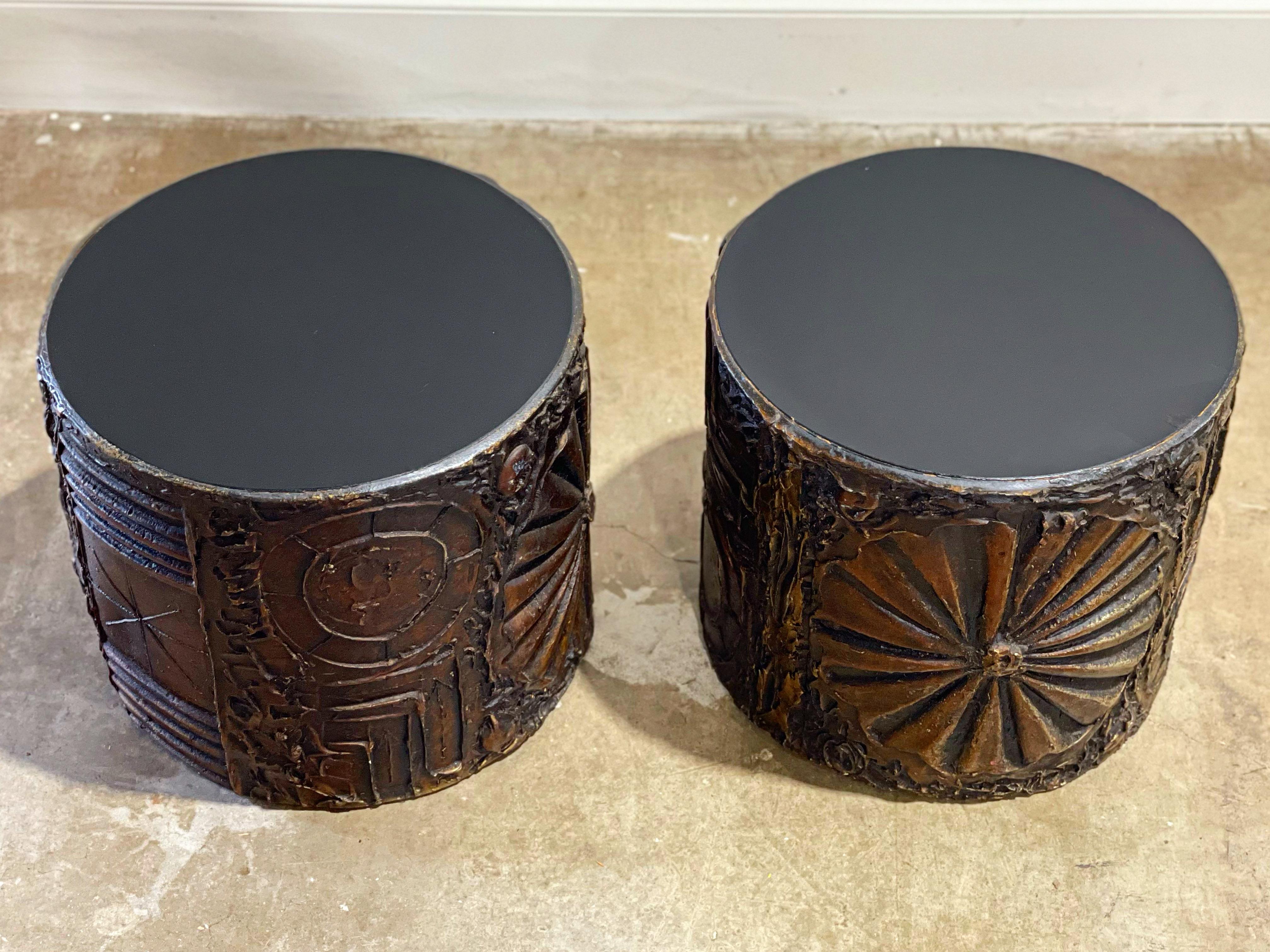 Brutalist style cylinder drum tables by Adrian Pearsall for Craft Associates, circa 1970s. Organic sculpted resin in warm tones of amber and bronze with durable black laminate tops. Tables are in excellent condition with no issues of note - each has