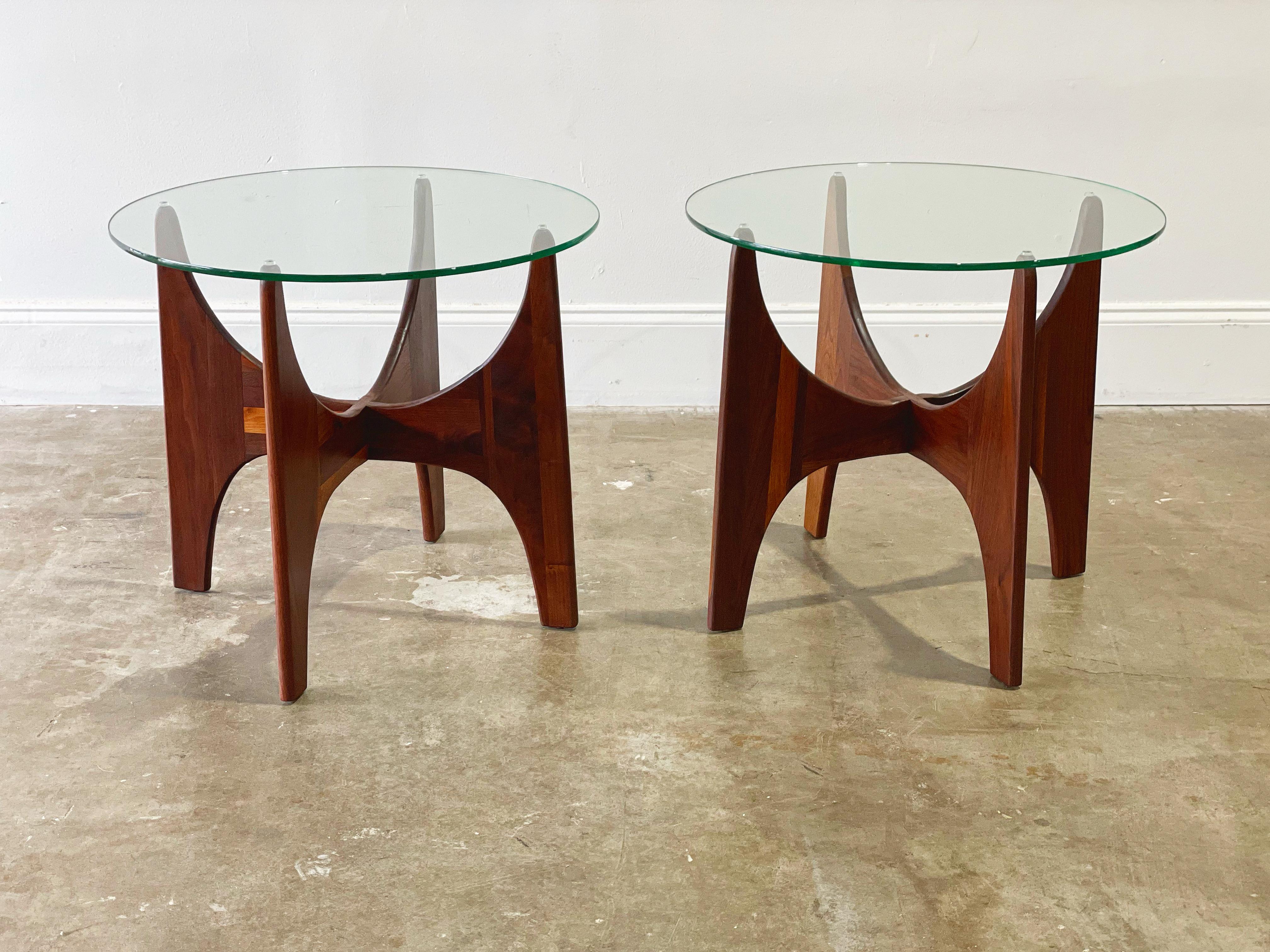 Pair of midcentury modern side tables by Adrian Pearsall for Craft Associates. Solid sculpted American black walnut and glass. Model 1924-T24. Gorgeous atomic silouhette. This pair has been fully restored by our team of in-house craftspeople and are