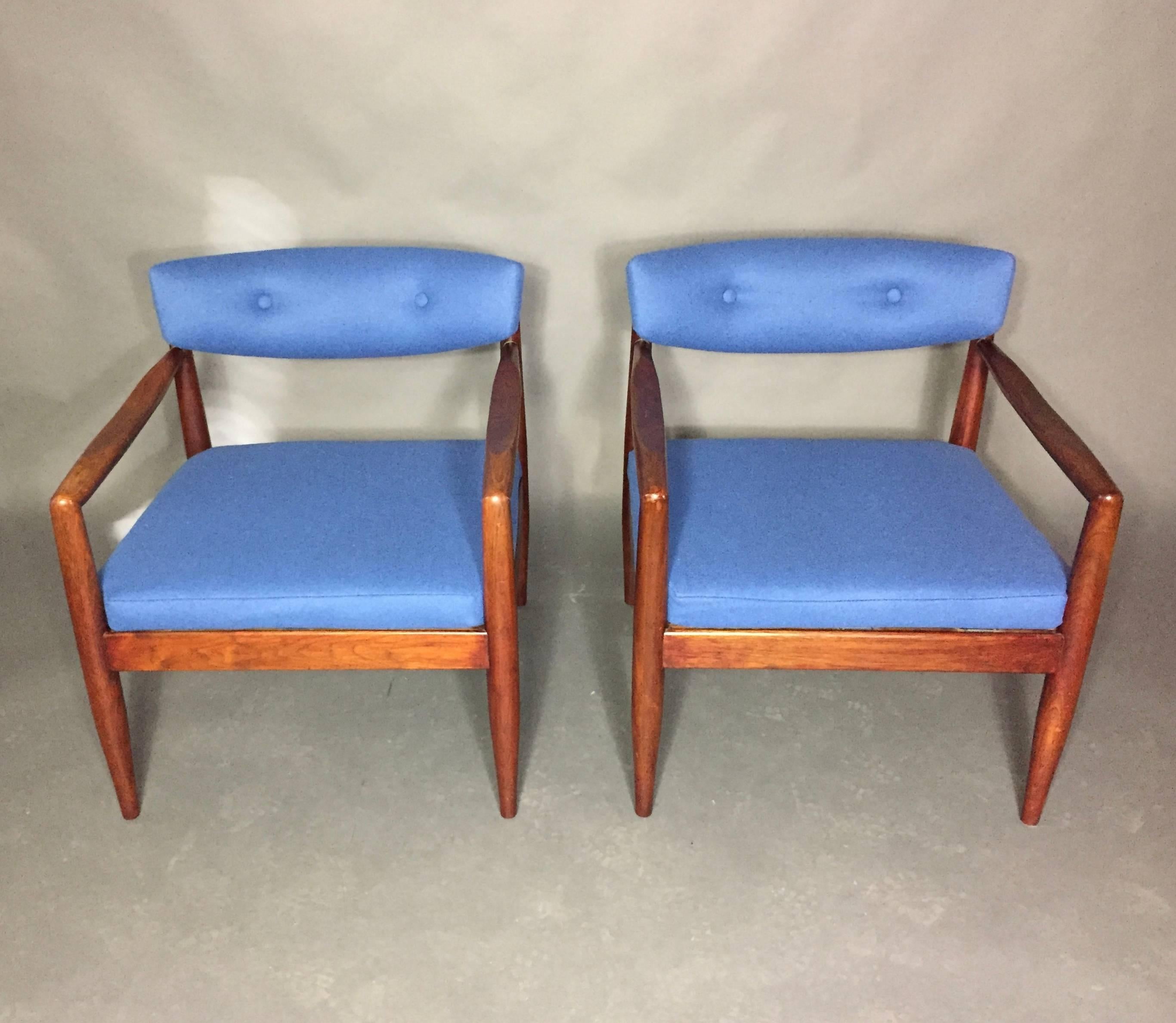 This pair was originally designed with an overstuffed seat cushion a bit extreme of the Pearsall lounge chairs. We shortened the seat to enhance the beauty of the chair with a shallow buttoned seat back that is slighted curved. Walnut frame with