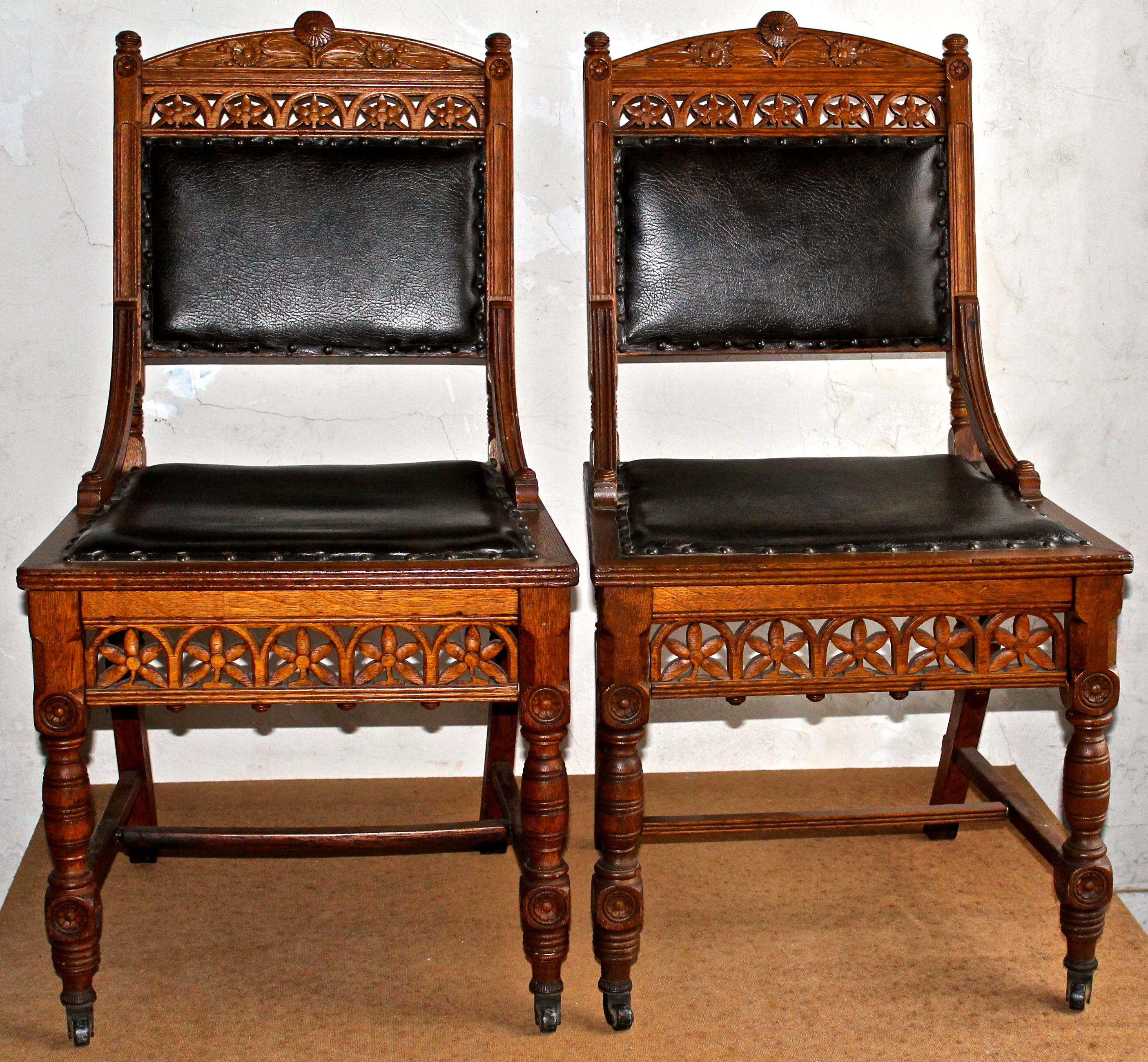 Aesthetic movement chairs beautifully carved oak or ash with great detail. Leather upholstered. India rubber Company New York wheels.