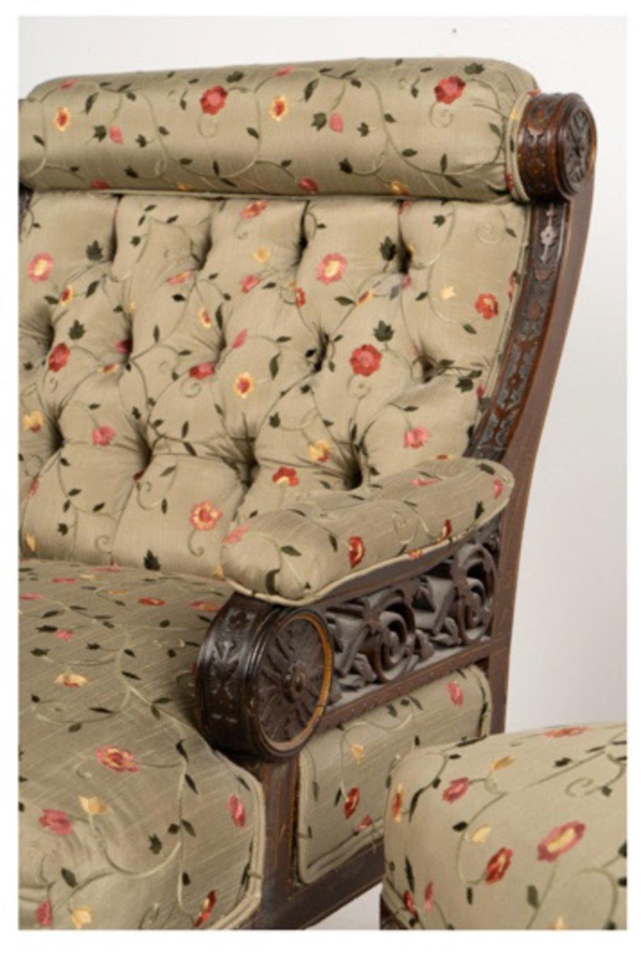 This is a striking pair of American Aesthetic Movement Parlor or Club Chairs in the style of Herter Brothers. These chairs are an unusual form of New York 19th century chair and are crafted of intricately carved rosewood with a gothic design