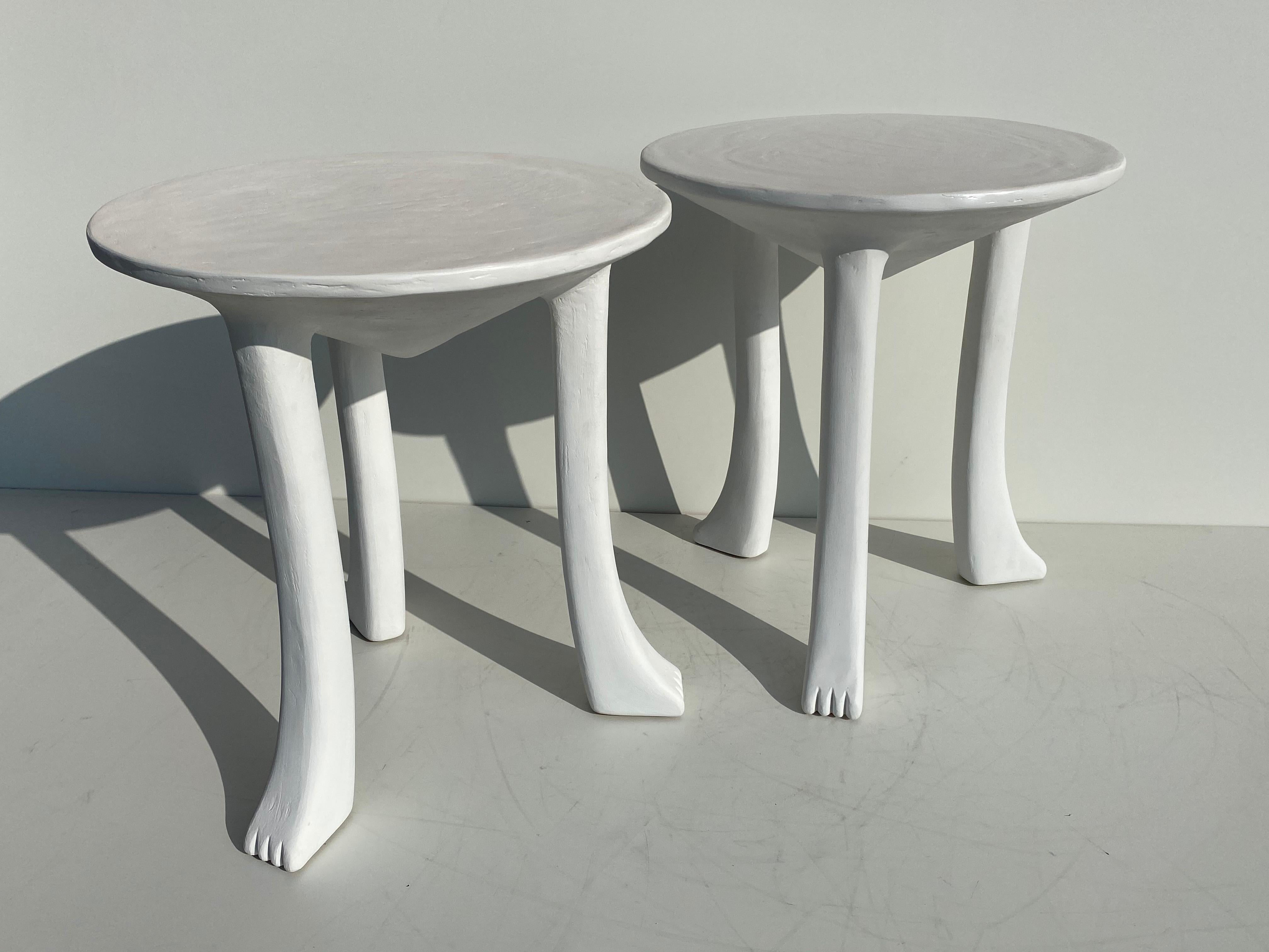 Pair of African plaster side tables in the style of John Dickinson. Made of solid wood and covered in plaster.