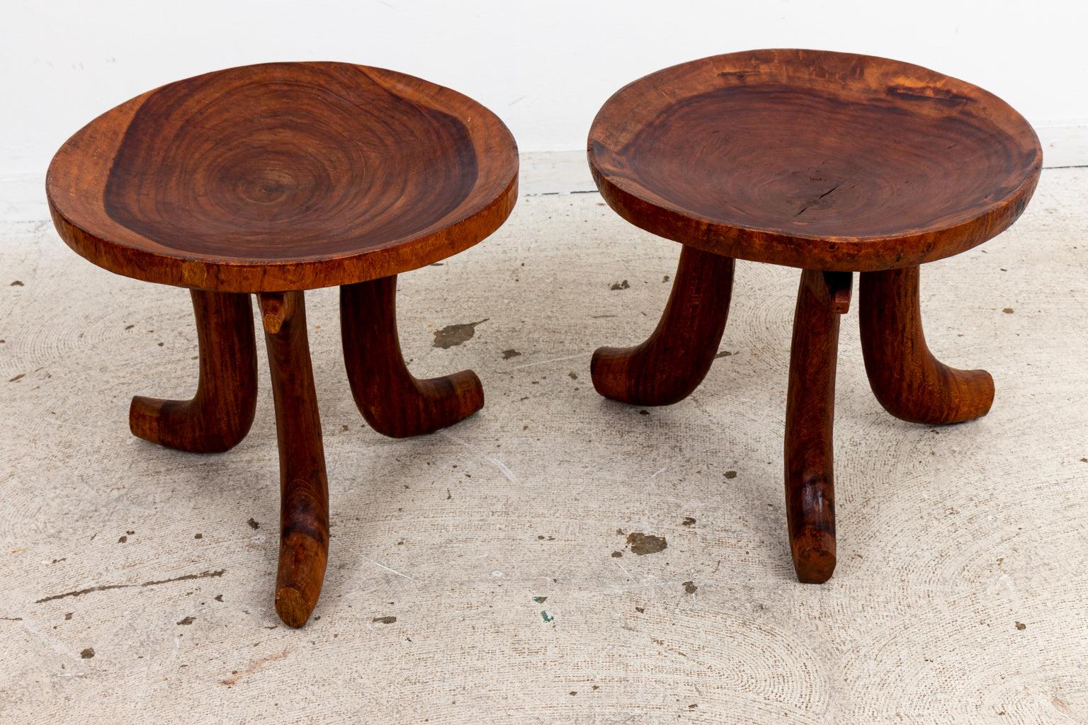 A pair of African sculptural dish form stools. Note of wear consistent with age.