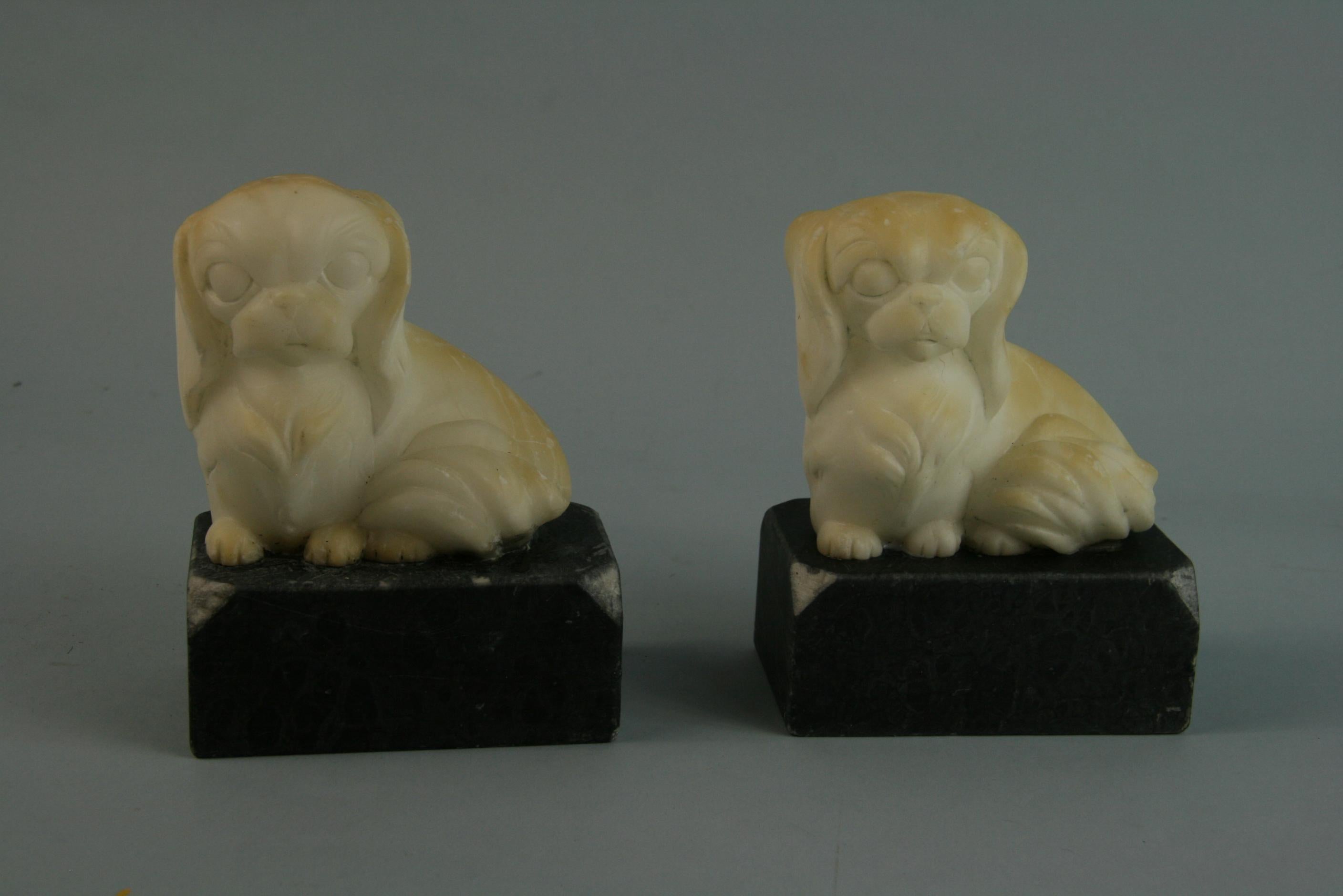 Pair alabaster dog bookends/sculptures on black marble base.
Price quoted is for the pair