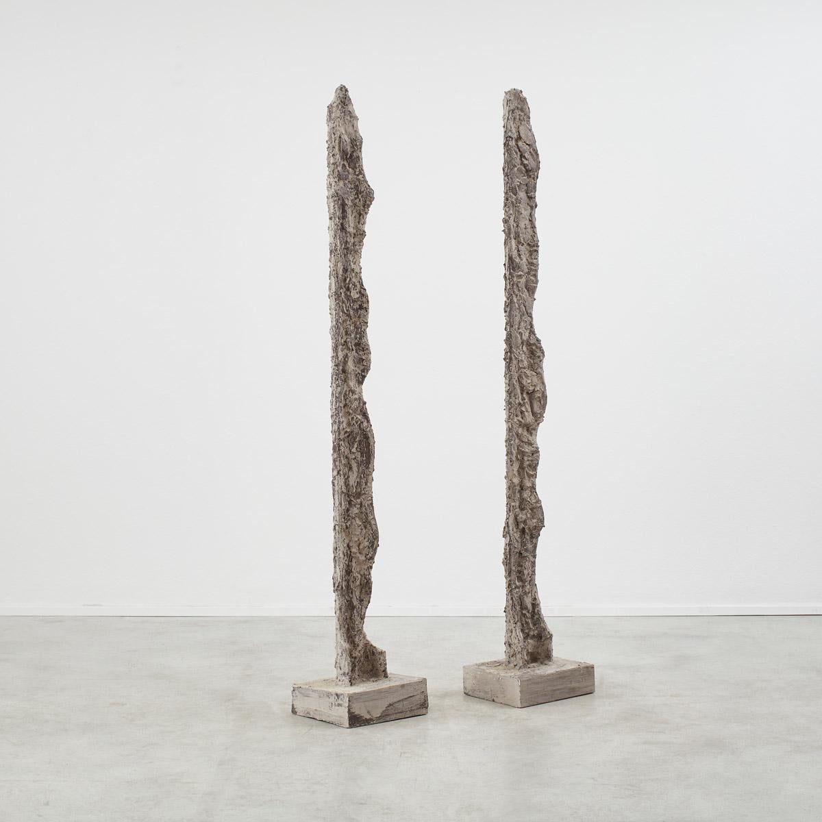 This pair of rocky totem sculptures tower up like stalagmites in a cave. Formed of clay onto an internal skeleton which makes the pieces light in nature. The pair of sculptures are in good vintage condition with the rough texture allowing any wear