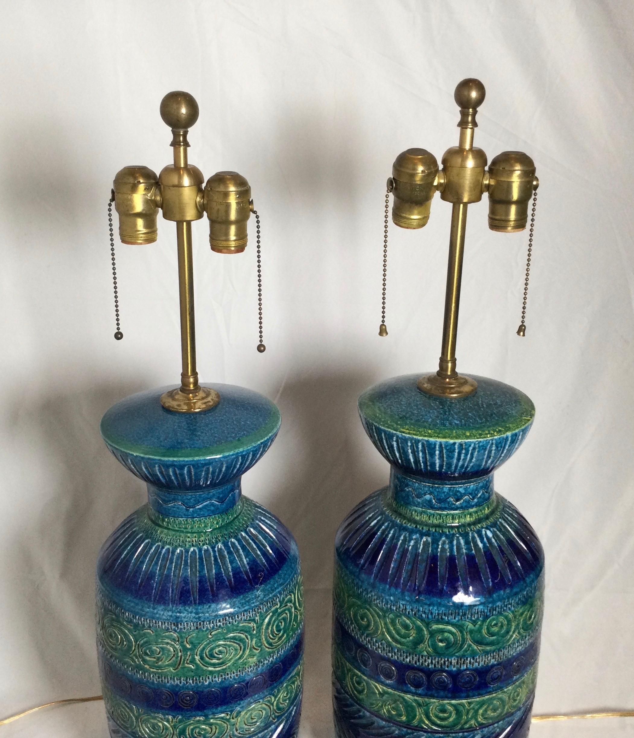 Pair of Aldo Londi Bitossi midcentury ceramic lamps. Handmade, slightly different from one another. Each carved in to the ceramic, wonderful colors. Measures: Approximately 8