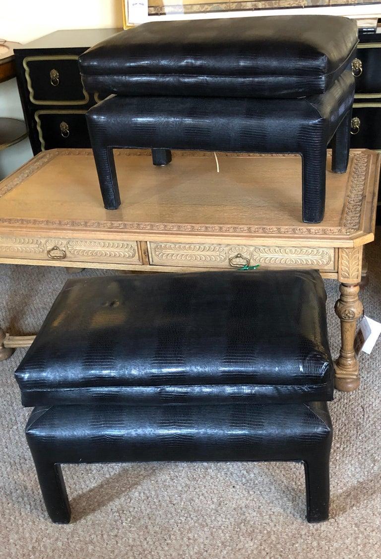 Pair of alligator or crocodile style faux leather cushioned foot stools or benches. This decorative and designer driven pair of stunning benches or footstools are certain to make a fine addition to any home or office. Each having a padded secondary