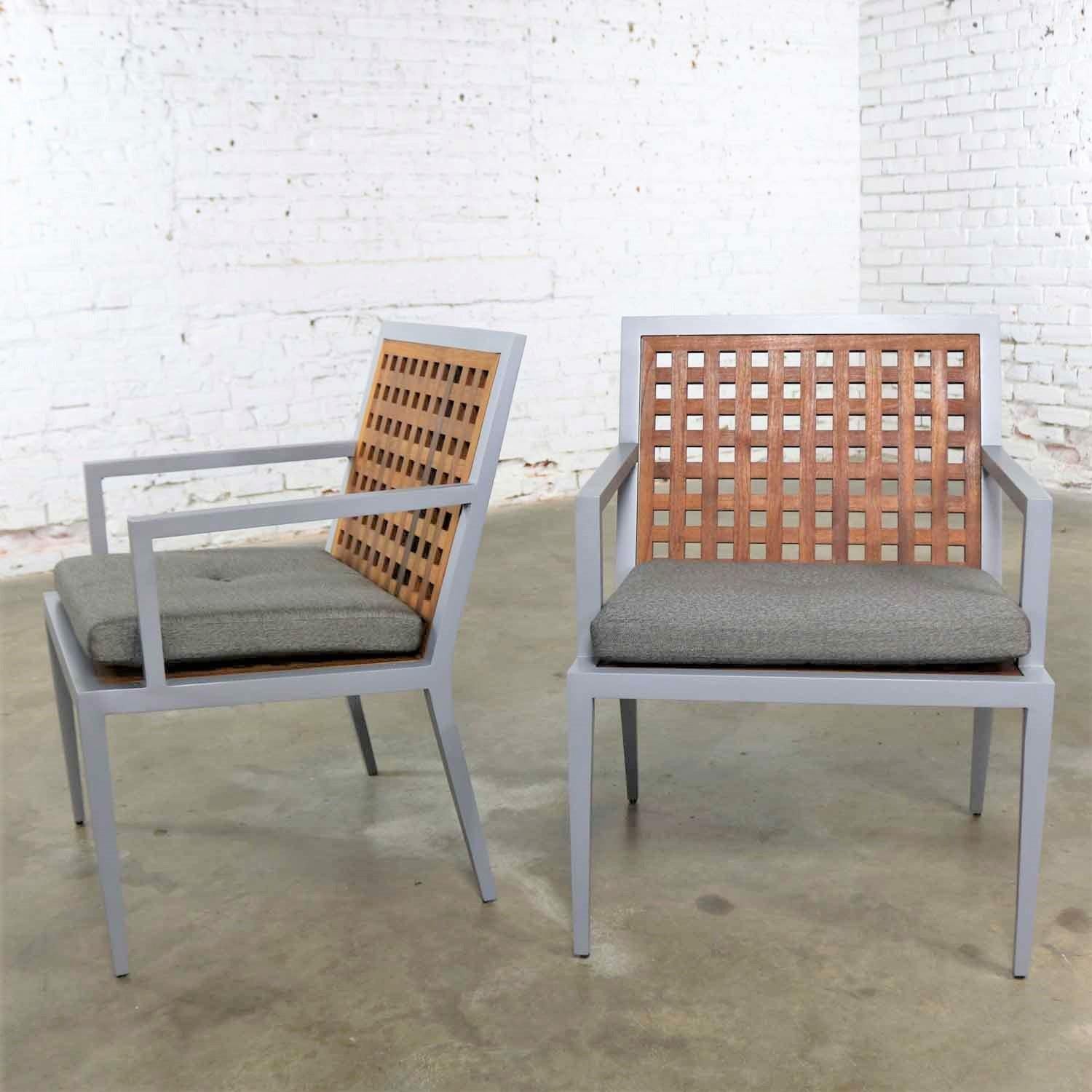 Handsome pair of patio chairs in teak and powder-coated aluminum with a removable seat cushion designed by Michael Vanderbyl for McGuire Furniture as part of their Archetype collection. They retain their original tags and are in fabulous vintage but