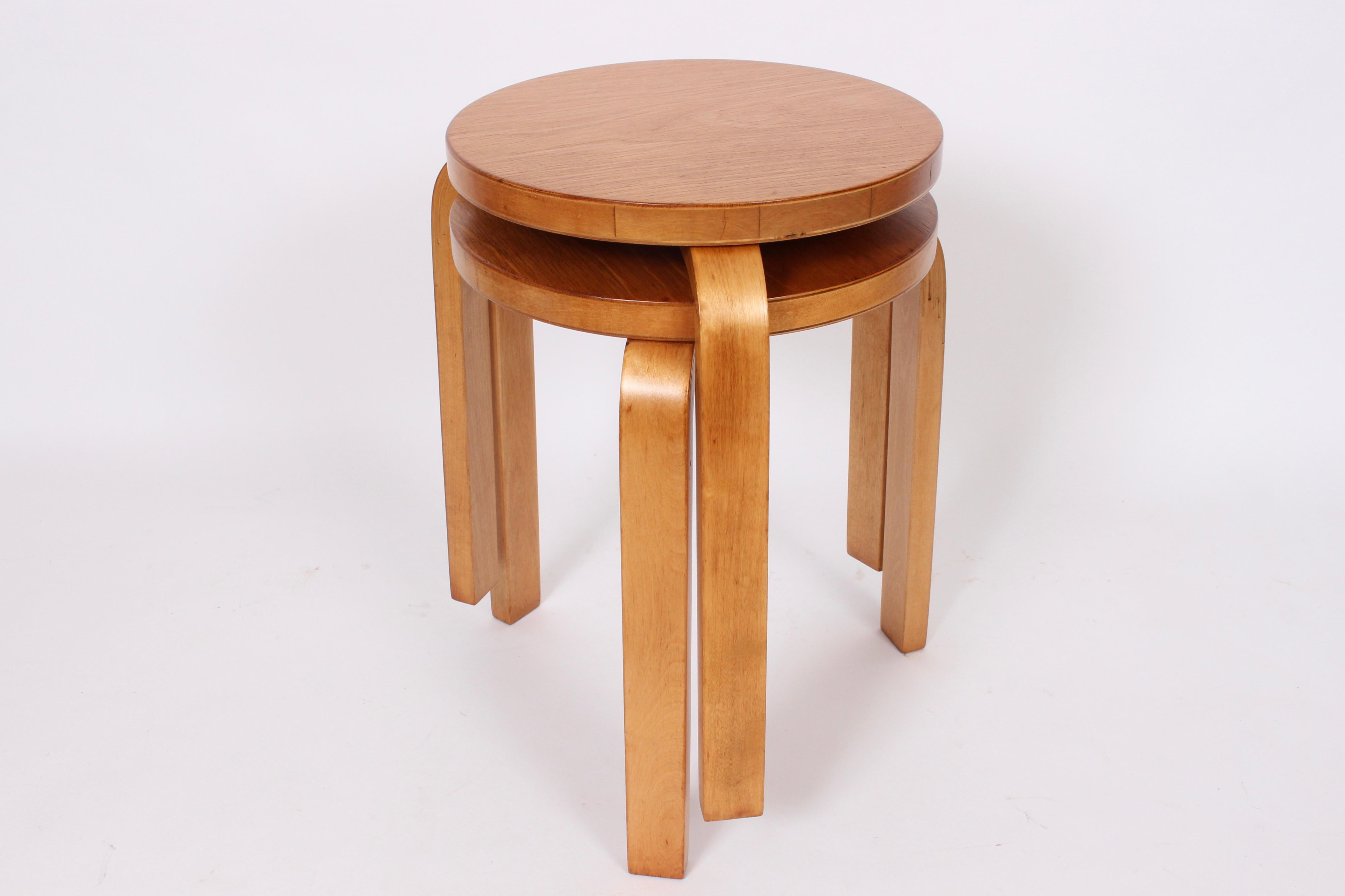 Early Alvar Aalto for Finsven model 60 beech and birch nesting tables. With reinforced tripod bentwood legs. Measures: 13 D seat. Classic. Modernist. Rarity. Finsven label to underside.
  