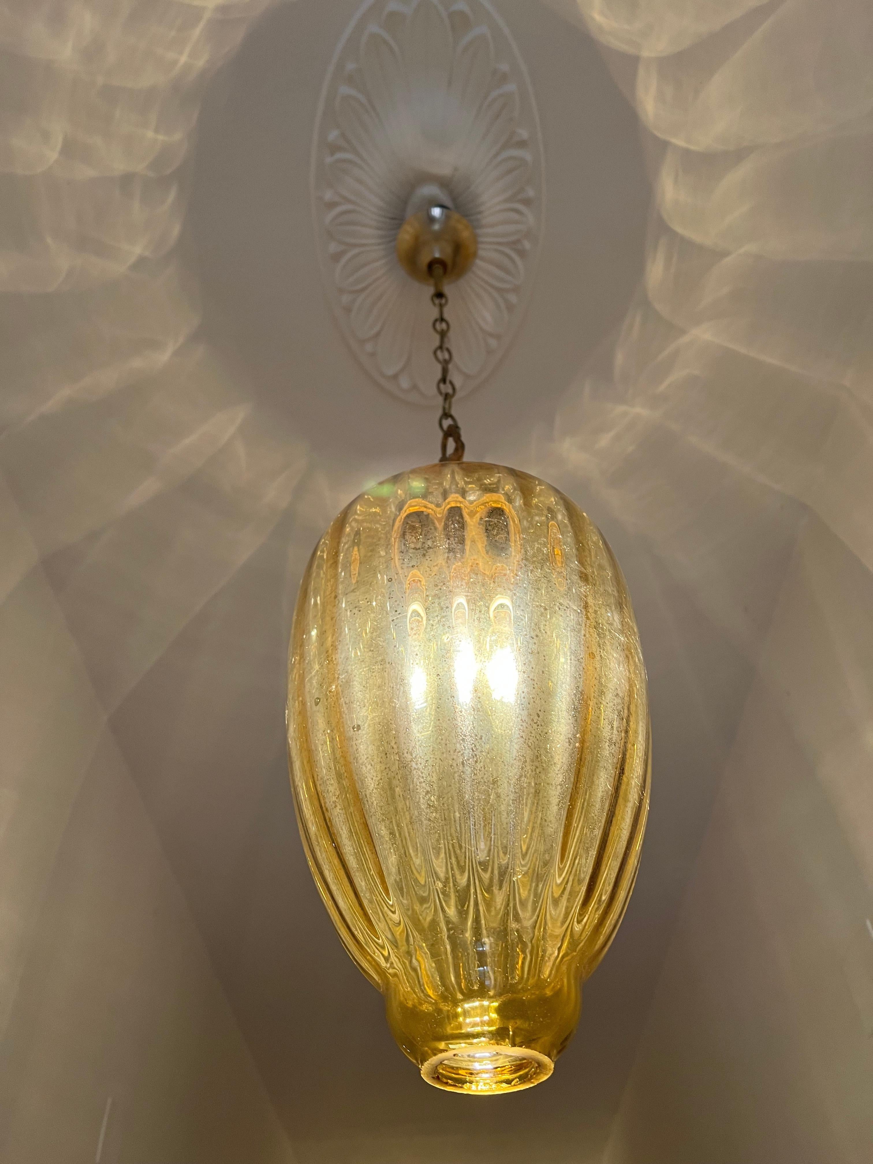 Gorgeous pair of amber-colored Mrrano glass lanterns. To give gorgeous light to even an anonymous hallway.