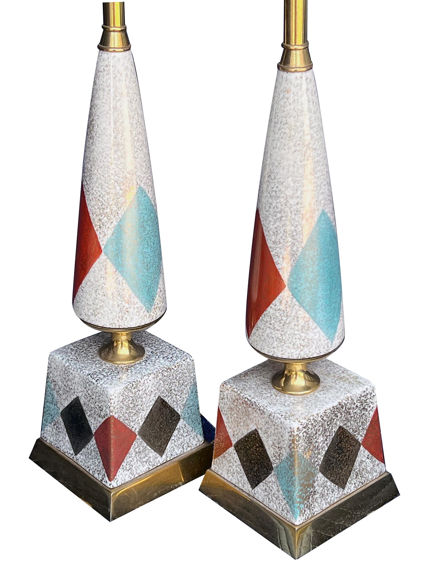 each with brass fittings and of conical form above a square plinth with harlequin pattern of vertically arranged contrasting diamonds all on an ivory ground with gilt flecking; height: 14.5