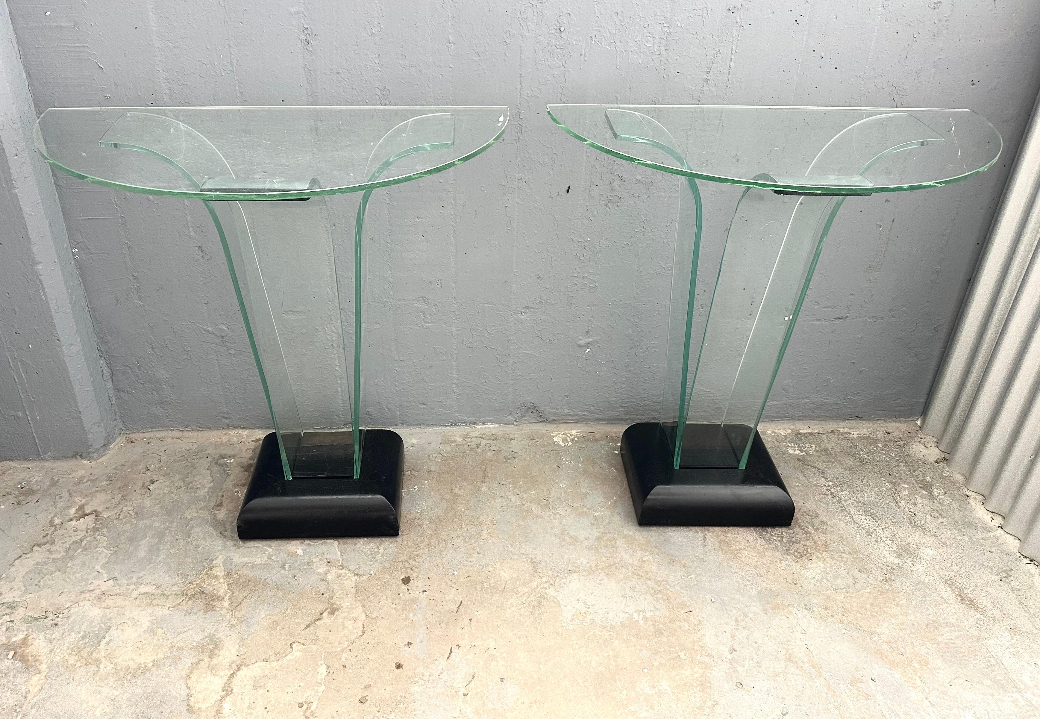 Fabulous vintage pair of curved glass and ebonized wood console tables, designed by Ben Mildwoff and manufactured by his industrial glass company.  Incredibly contemporary looking, this true Art Deco design epitomizes the early modernist fascination