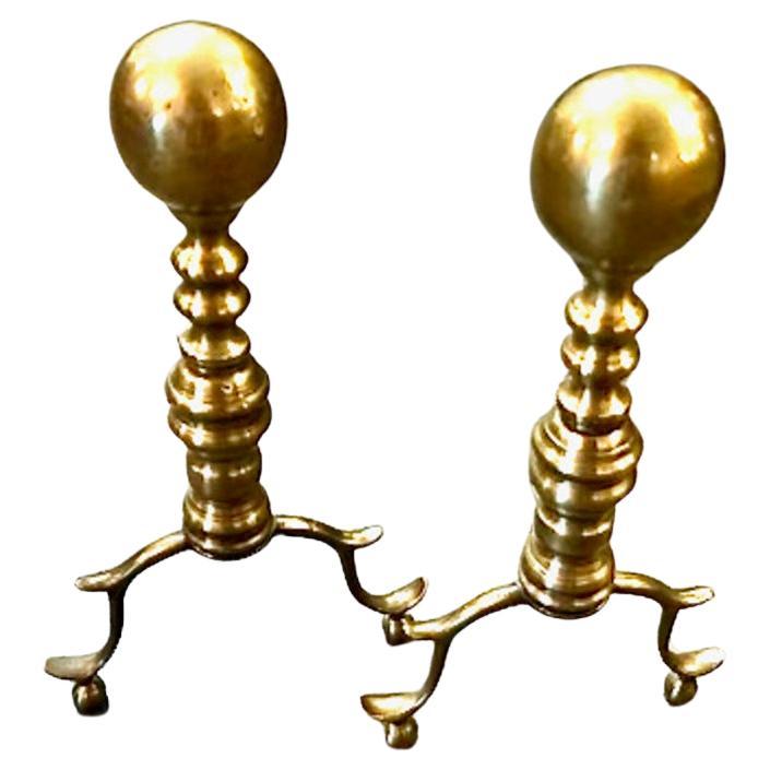 This is a charming small pair of period Federal Cannonball Andirons. The andirons are in overall very good condition, with restoration to the iron log supports. These andirons, with their original patinated base surface, would be the perfect