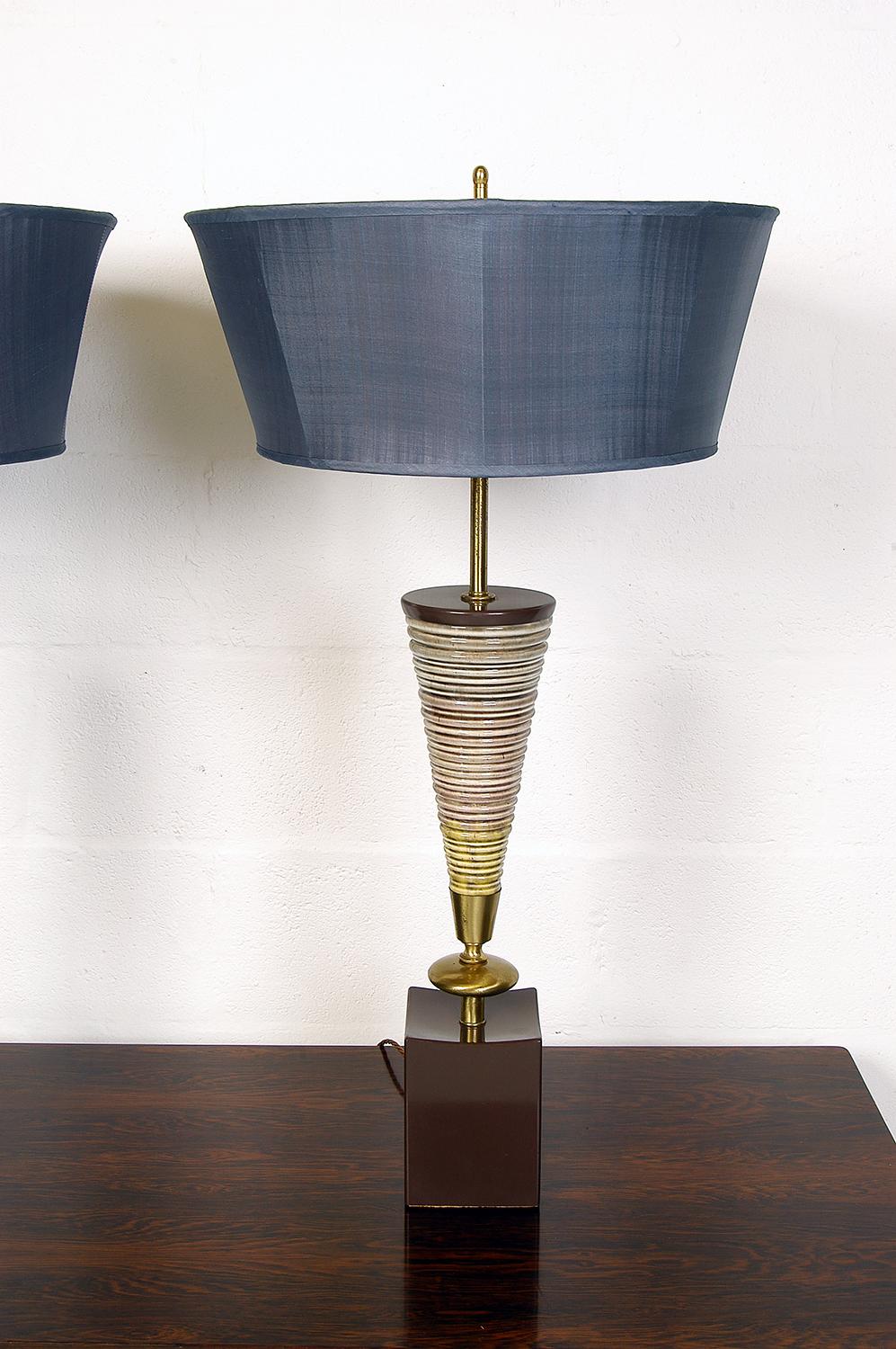 A large pair of dramatic American Mid-Century Modern ceramic and brass table lamps by The Rembrandt Lamp Company of Chicago USA. Part of their ‘Masterpieces’ series, the lamps - including the opaque diffusers - stand an impressive 91cm tall. Fitted