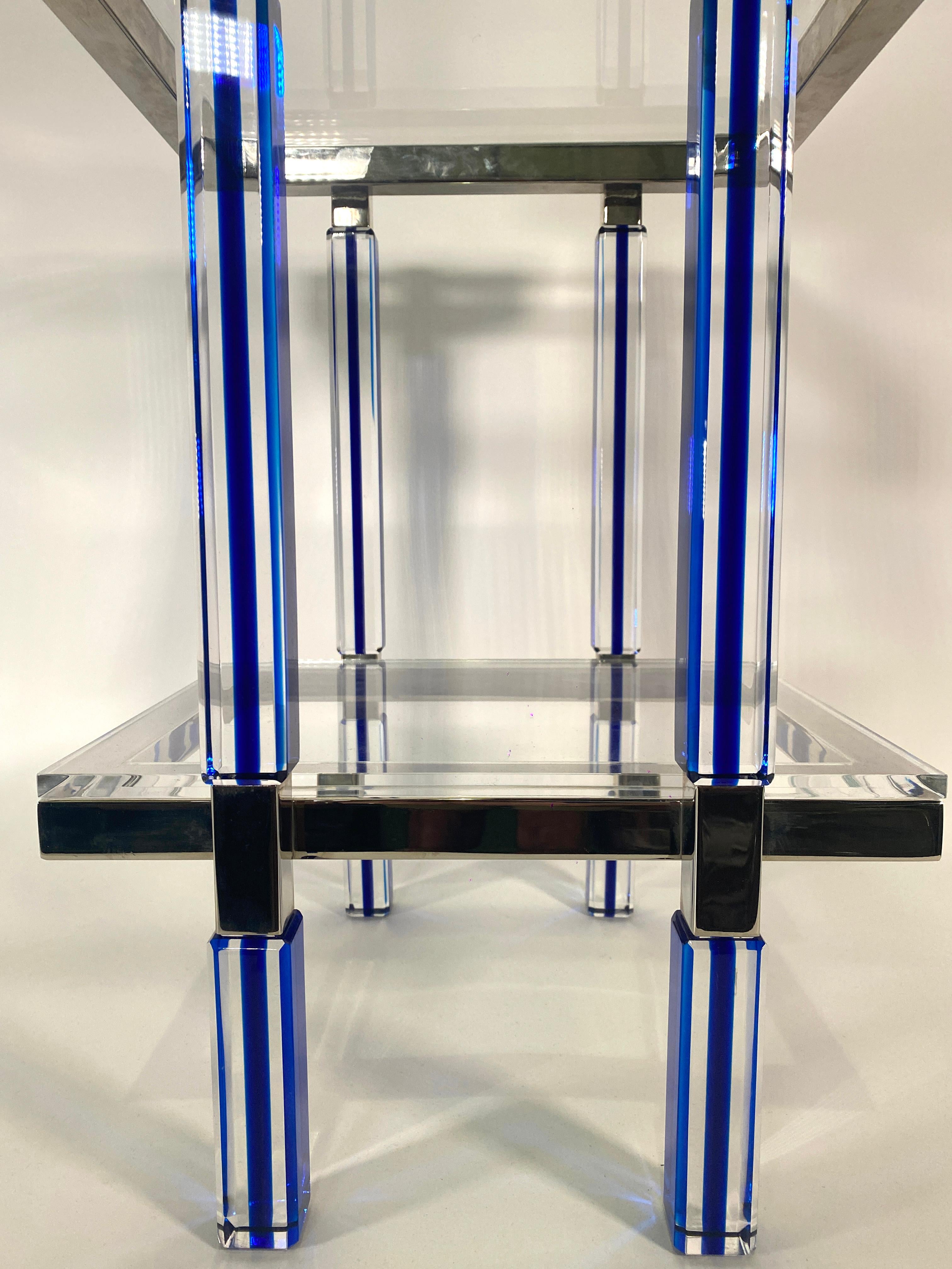 the lucite top above a nickel frame on striped clear and azure blue lucite legs, with a second tier with lucite top. Production of these will be limited to 12 pieces. We are exclusive dealers of these tables for Charles Hollis Jones.
 
**These are