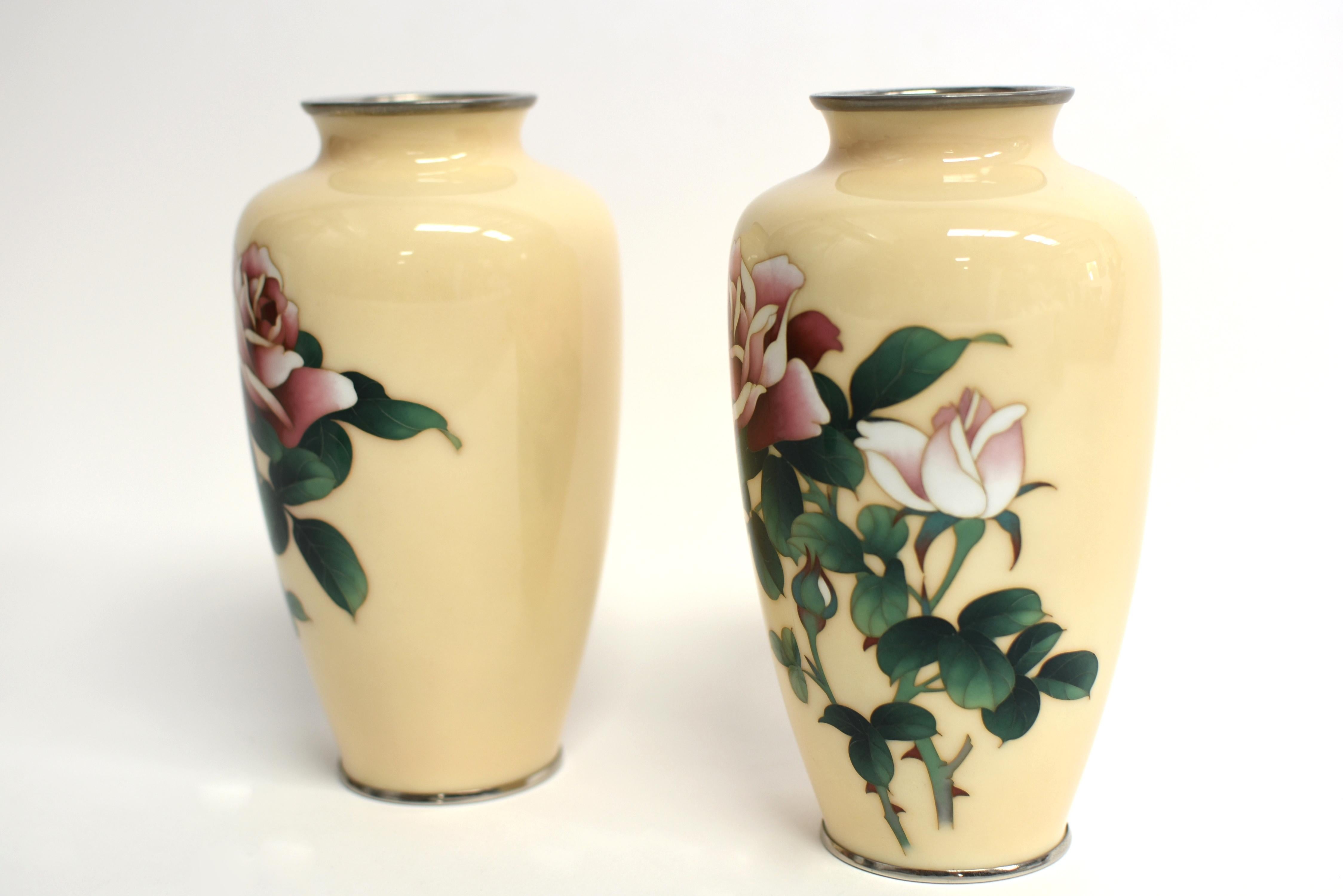 A very rare offering of pair of beautiful Ando Jubei (1876-1956) Rose vases in excellent condition. In classic form with elegant raised shoulders, the master artist employed superb wireless technique and colored enamels of butterscotch, burgundy,