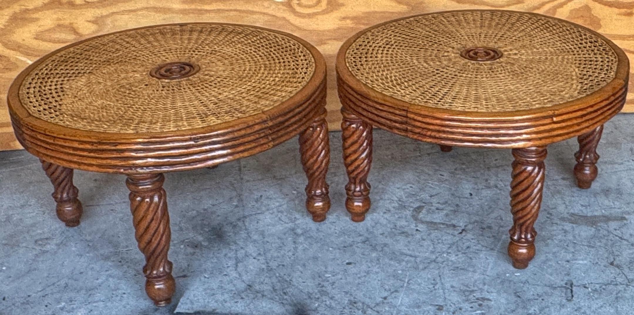 Pair of Anglo-Indian/Tradewinds-Style Carved Hardwood and Cane Low Tables/Benches 

A pair of low circular tables or benches in the Anglo-Indian or Tradewinds style, constructed from hardwood with handwoven cane tops. Each table features a thick,