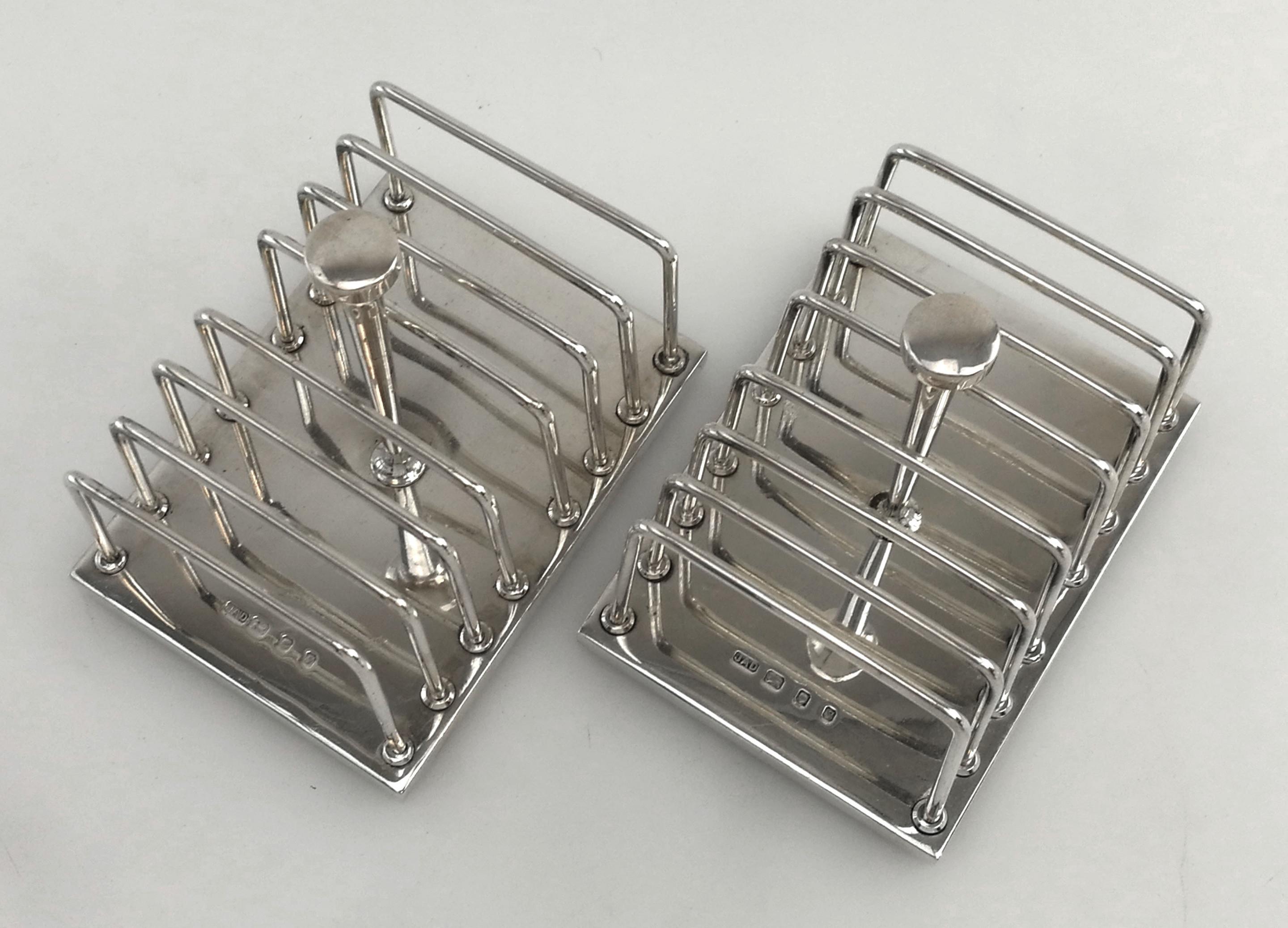 A wonderful pair of Post War modernist sterling silver Toast Racks designed by the esteemed Silversmith Anthony Elson. These Toast Racks feature simple, clean lines and an elegant design.
 
 Made in London in 1973 by JAD and Designed by Anthony