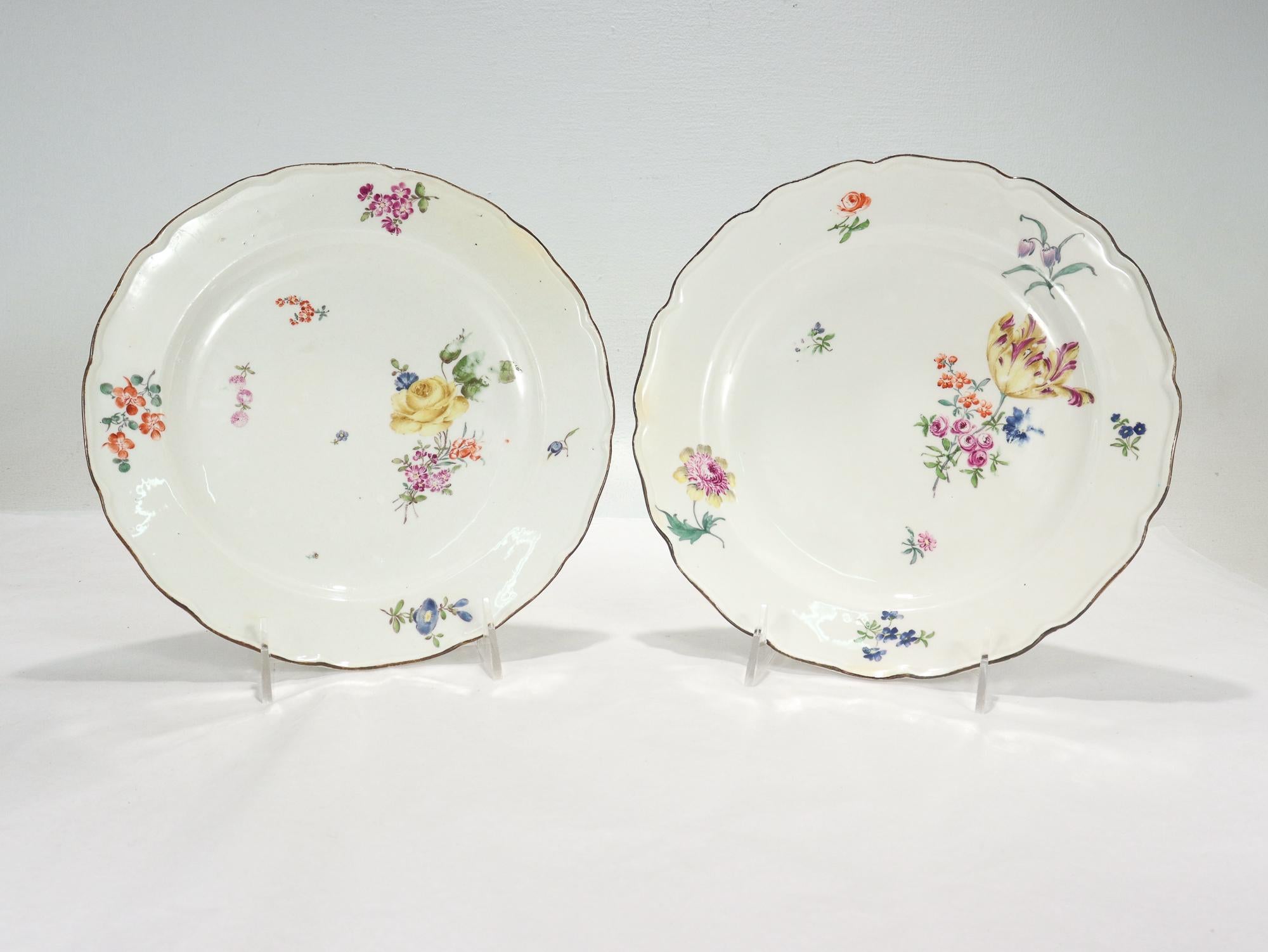 A fine pair of antique Neuer Ausschnitt (New Cut) pattern porcelain plates.

By the Royal Meissen Porcelain Manufactory.

Decorated with Deutsche Blumen floral sprays to the center and sides including roses, tulips, morning glories, and other