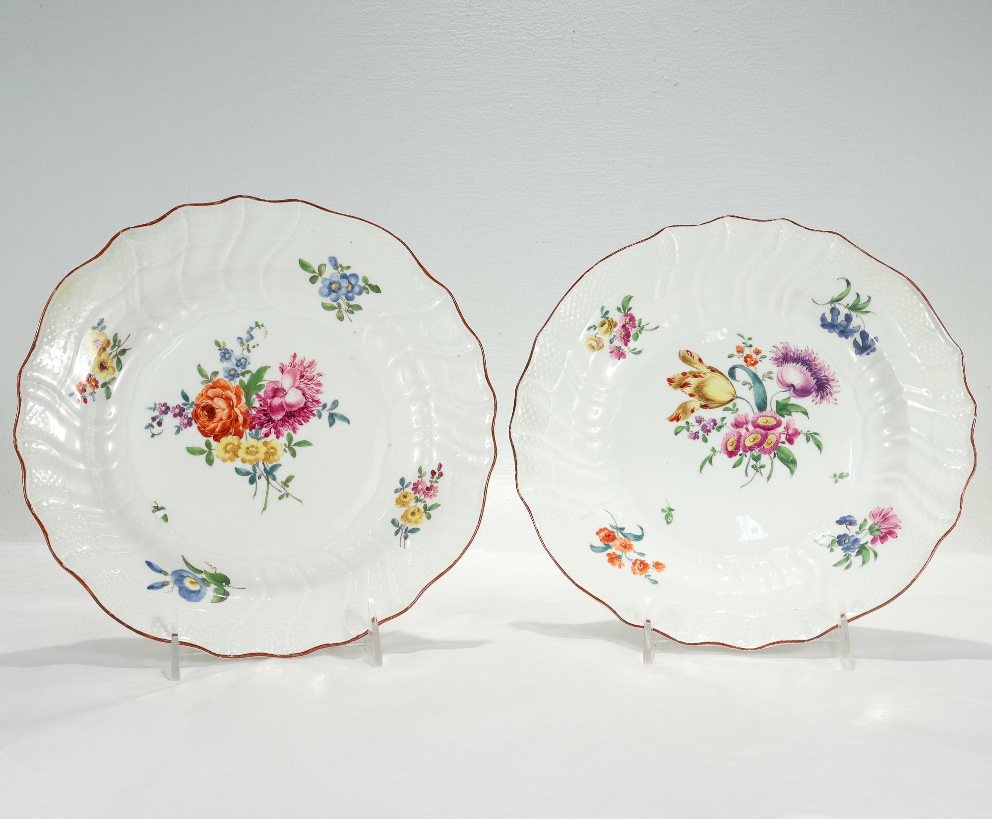 A fine pair of antique Neuozier pattern plates.

By the Royal Meissen Porcelain Manufactory.

Decorated with Deutsche Blumen floral sprays to the center and sides including roses, tulips, morning glories, and other various flowers. 

The