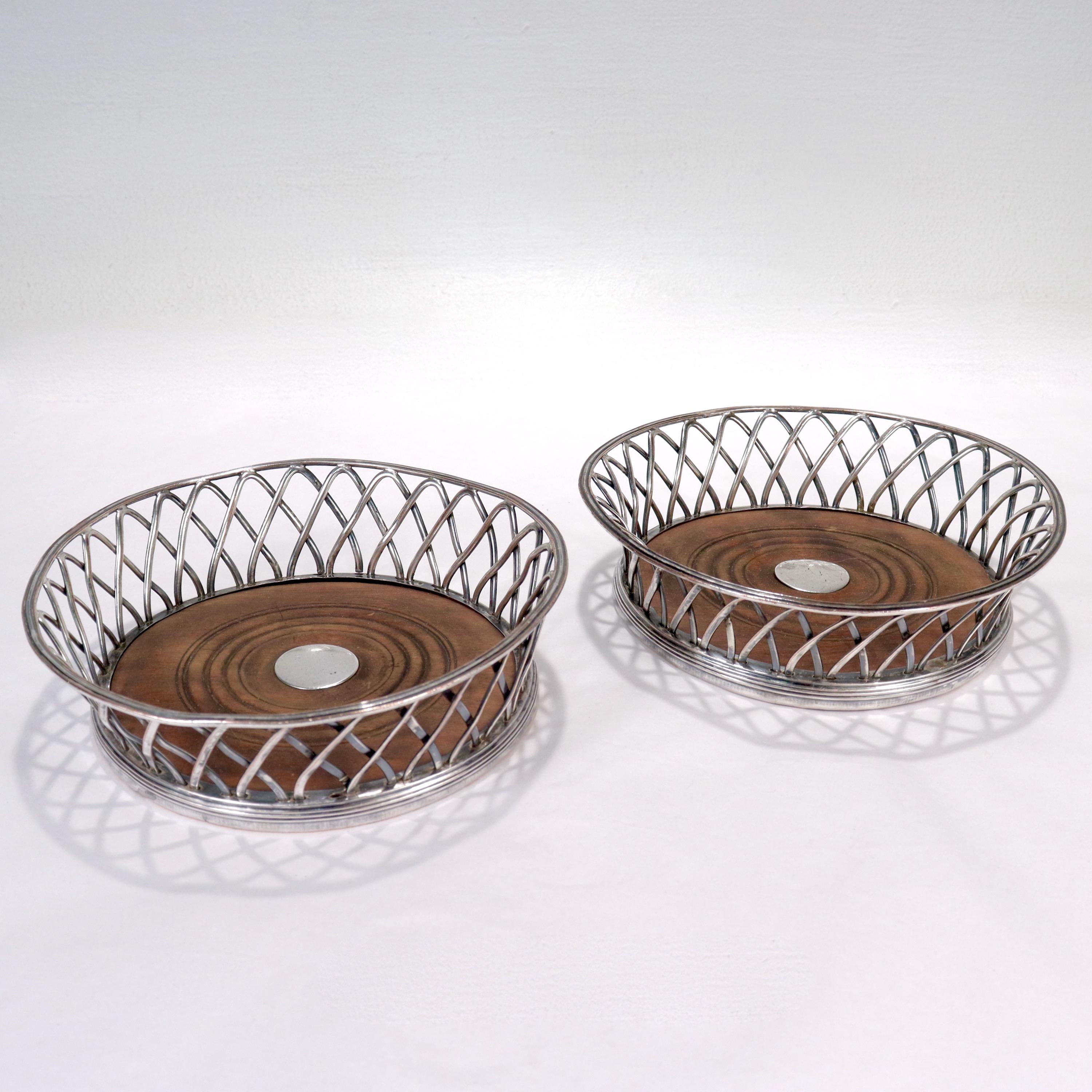 A fine pair of antique Sheffield silver plate wine coasters. 

In the form of wirework baskets.

With Sheffield type silver plate on copper and turned wooden bases.

Simply a great pair of Period wine coasters!

Date:
Late 18th or Early 19th