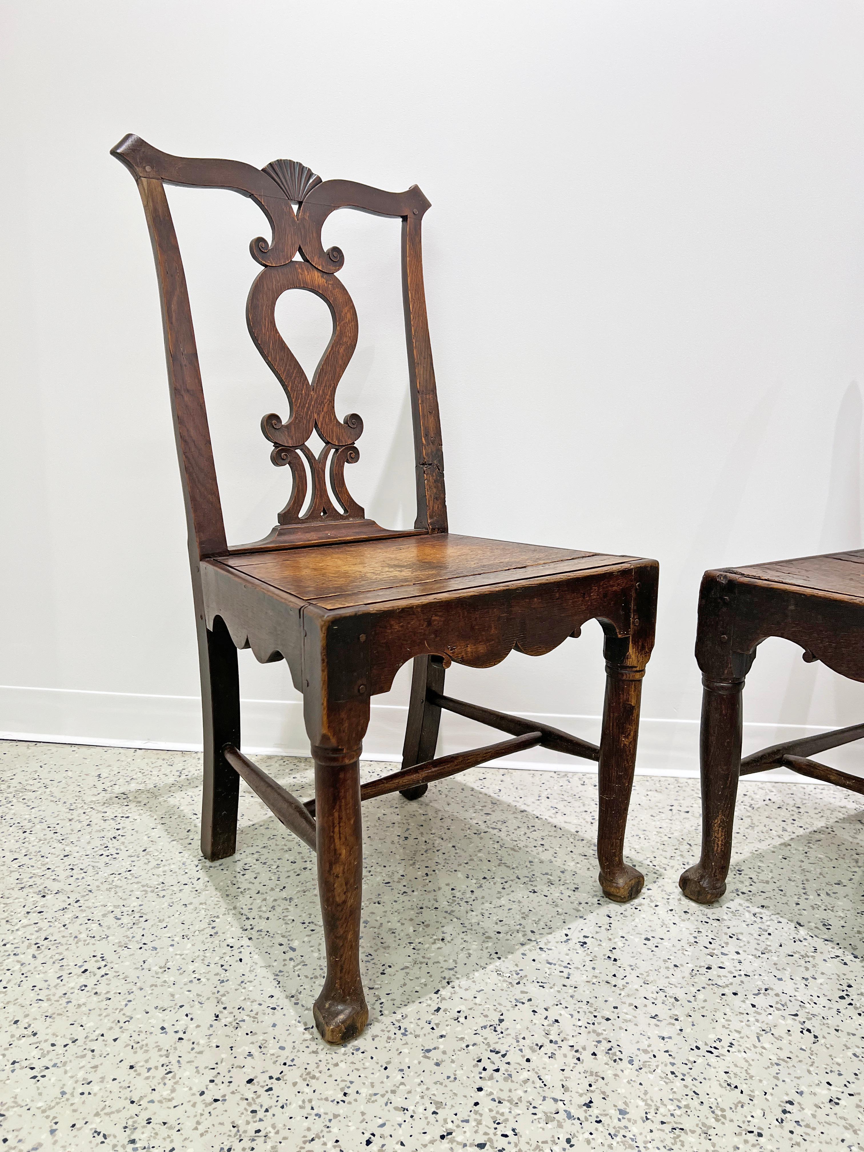 Pair of Irish Chippendale style chairs in white oak, ca. mid to late 18th century. These were most likely made for a country squire, as their more naturalistic and rustic bearing sets them apart from the period archetype. Seat rails and apron are