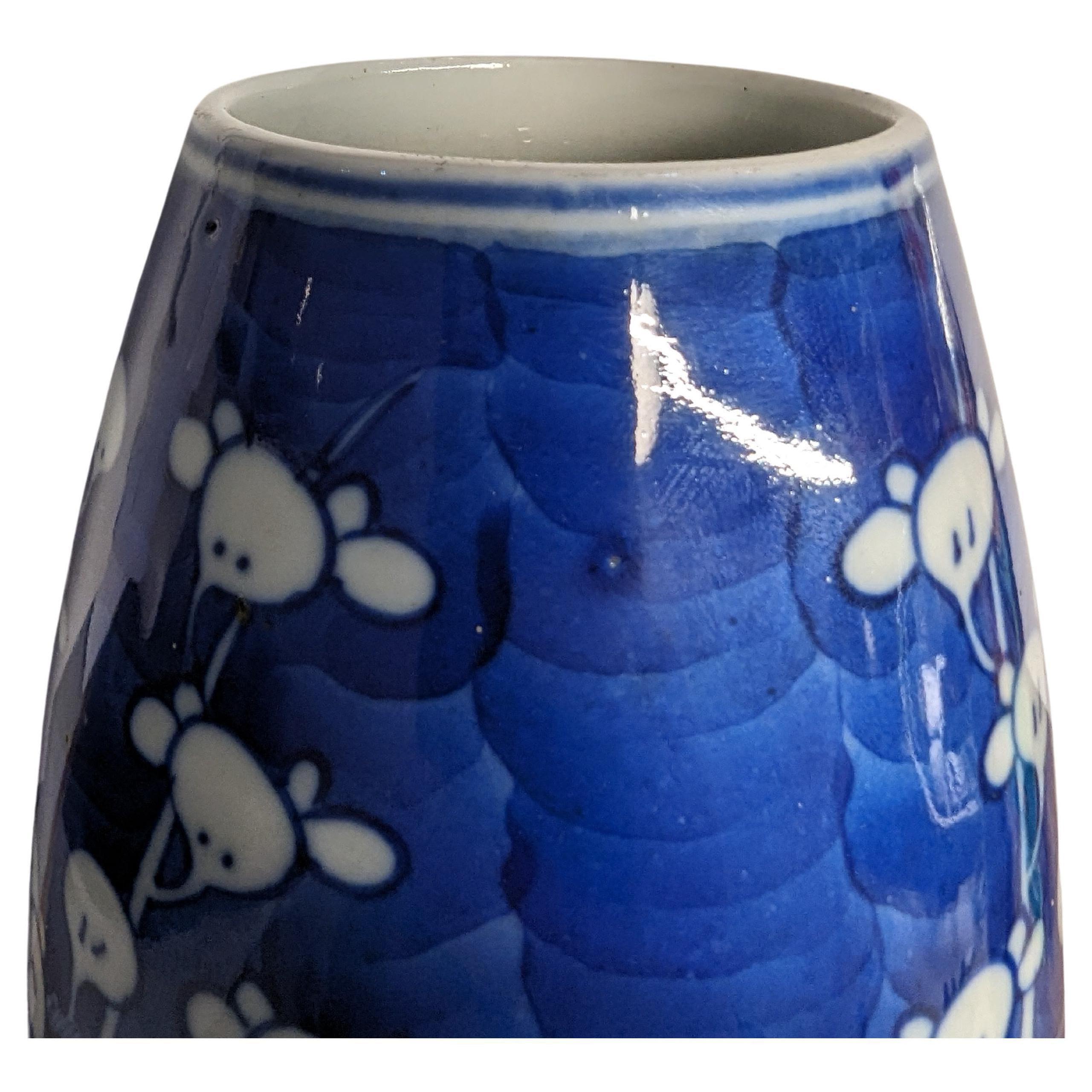 A matching pair of antique 19c Chinese blue and white vase of elongated barrel form, hand painted with sprays of prunus blossoms in reserve on cobalt blue ground, drilled four character Kangxi makers to the base inside the foot ring, turned into